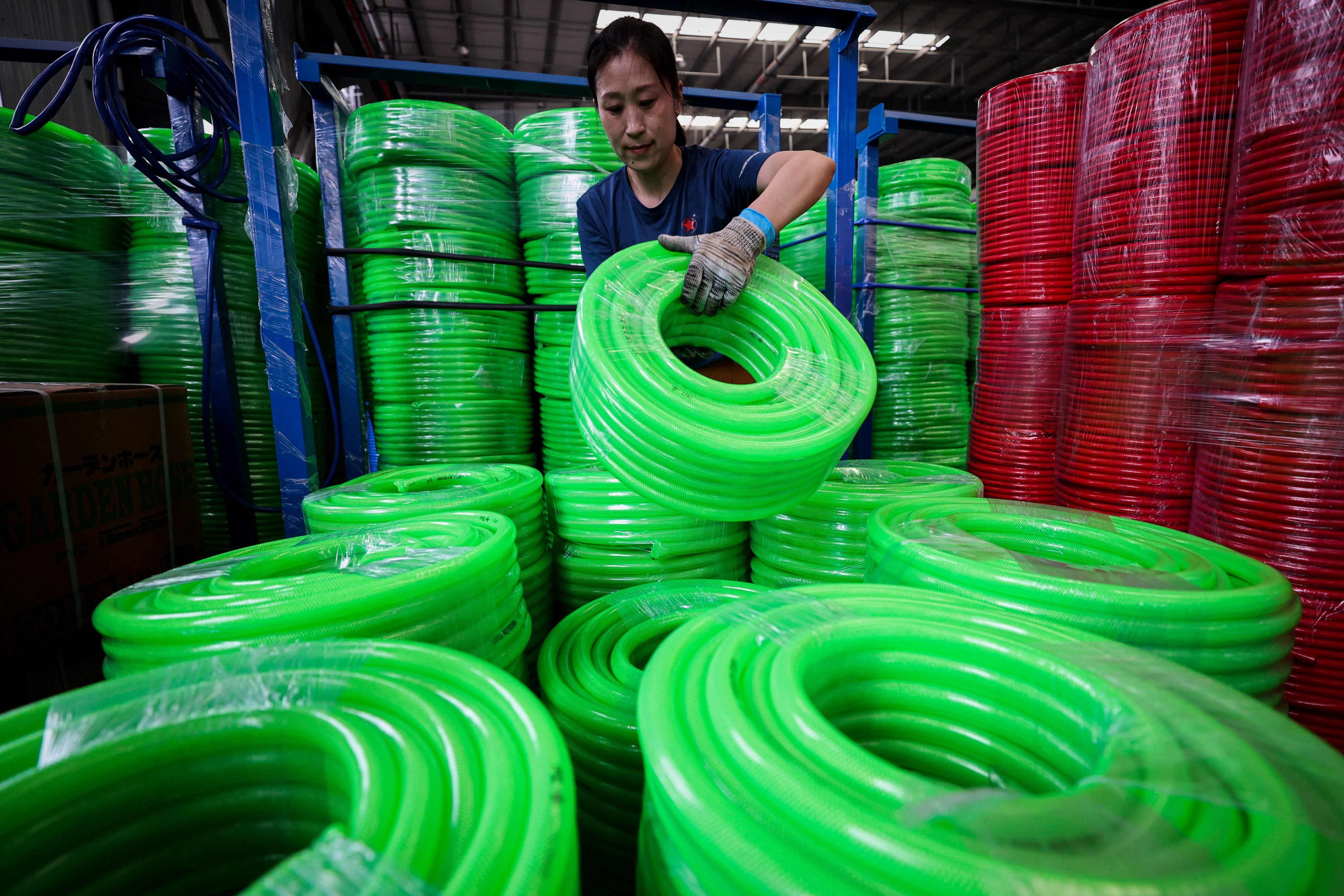An employee works on a production line at a factory that produces polyethylene flexible pipes for export in Lianyungang, Jiangsu province, on June 20. China’s exports continue to look strong, but concerns persist about the property sector and other parts of the economy. Photo: AFP