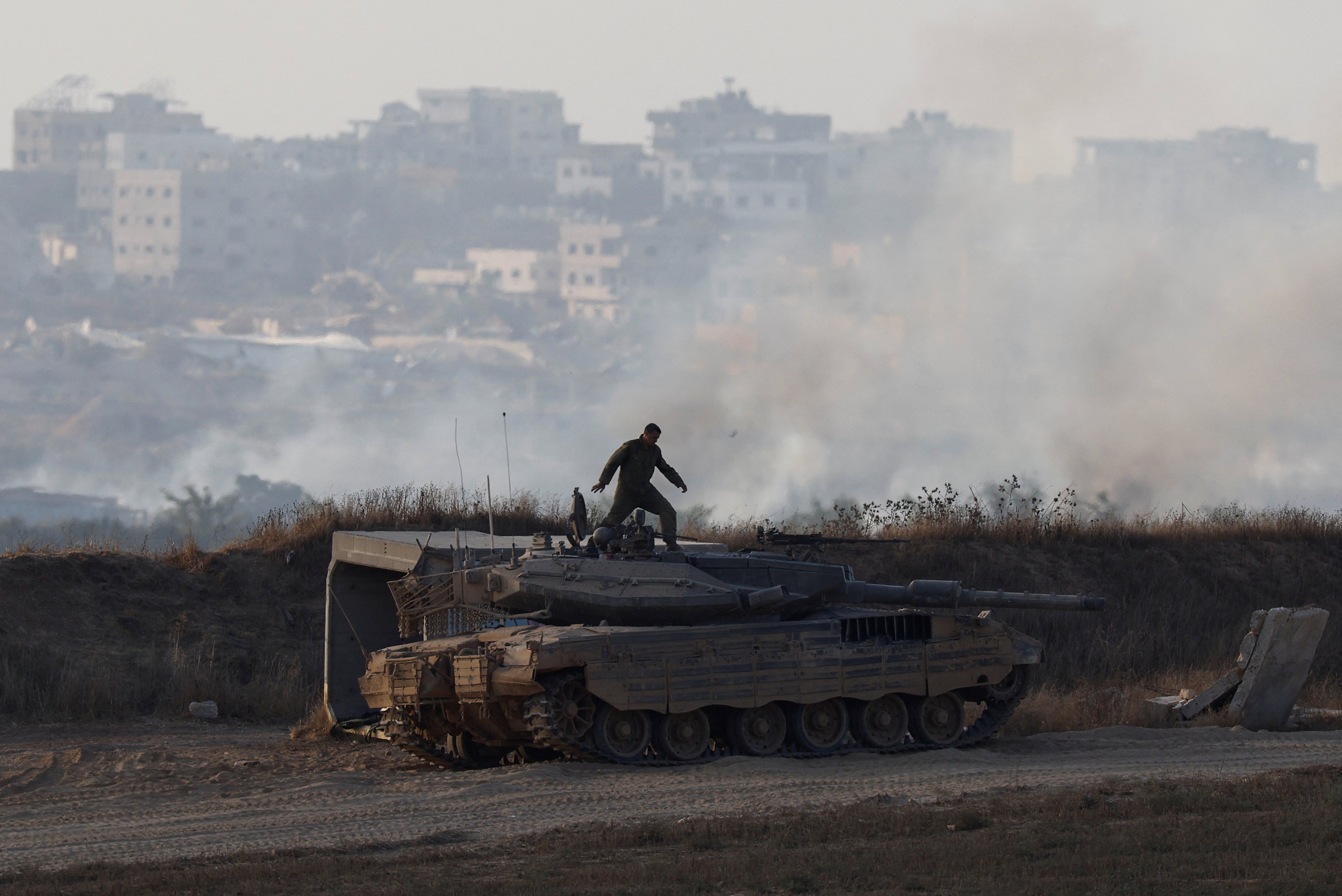 An Israeli soldier stands on top of a tank near the Israel-Gaza border, in Israel. Photo: Reuters