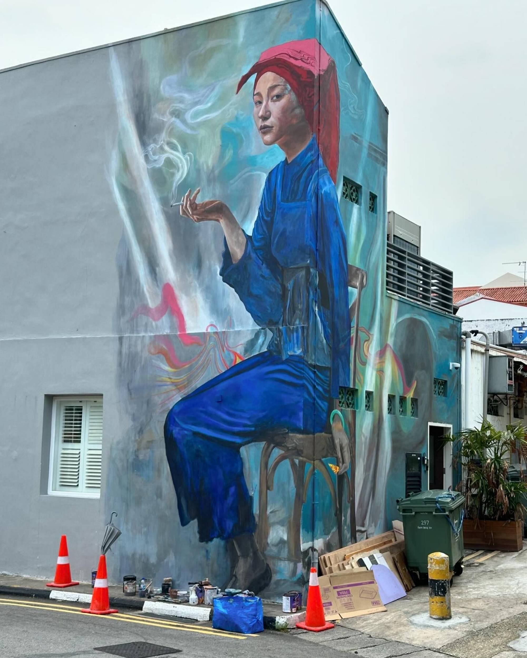 The mural depicts a young Samsui woman holding a smoking cigarette. Photo: Instagram/@seanpdunston