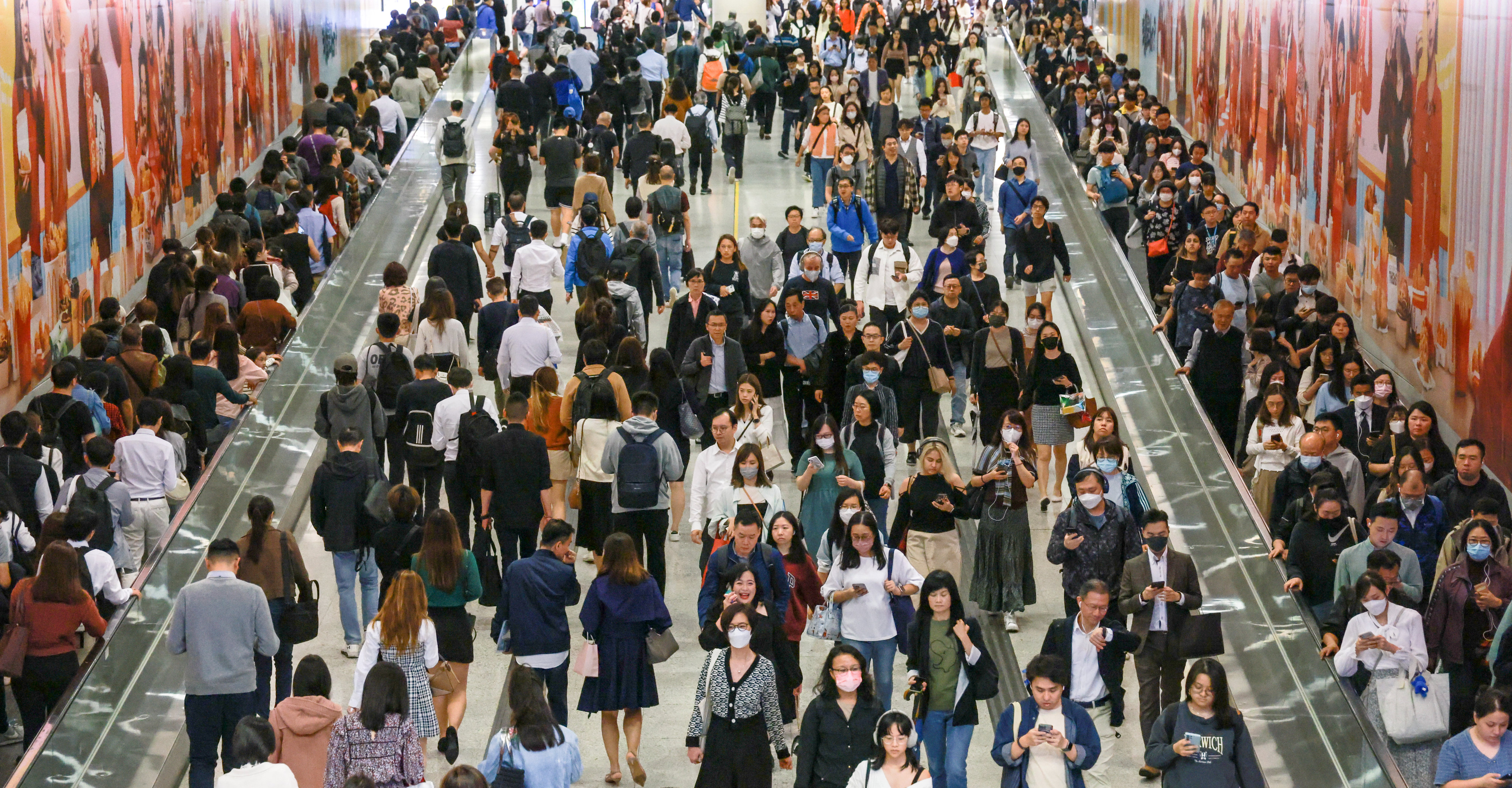 Commuters walk between the Central and Hong Kong MTR stations in the Central district of Hong Kong on February 20, 2024. Photo: May Tse