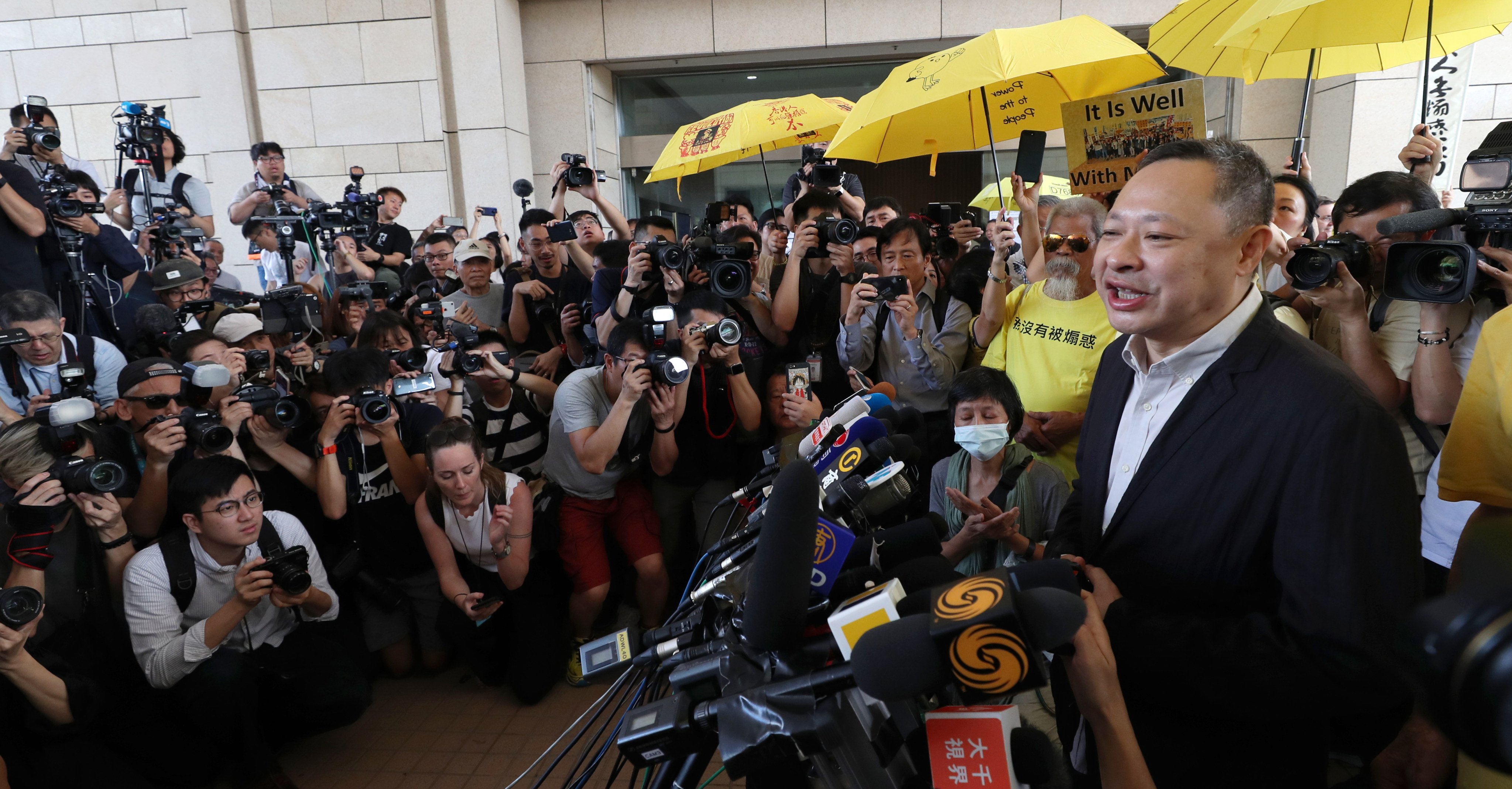 Benny Tai (right) speaks to the media outside West Kowloon Court in 2019. Photo: Robert Ng