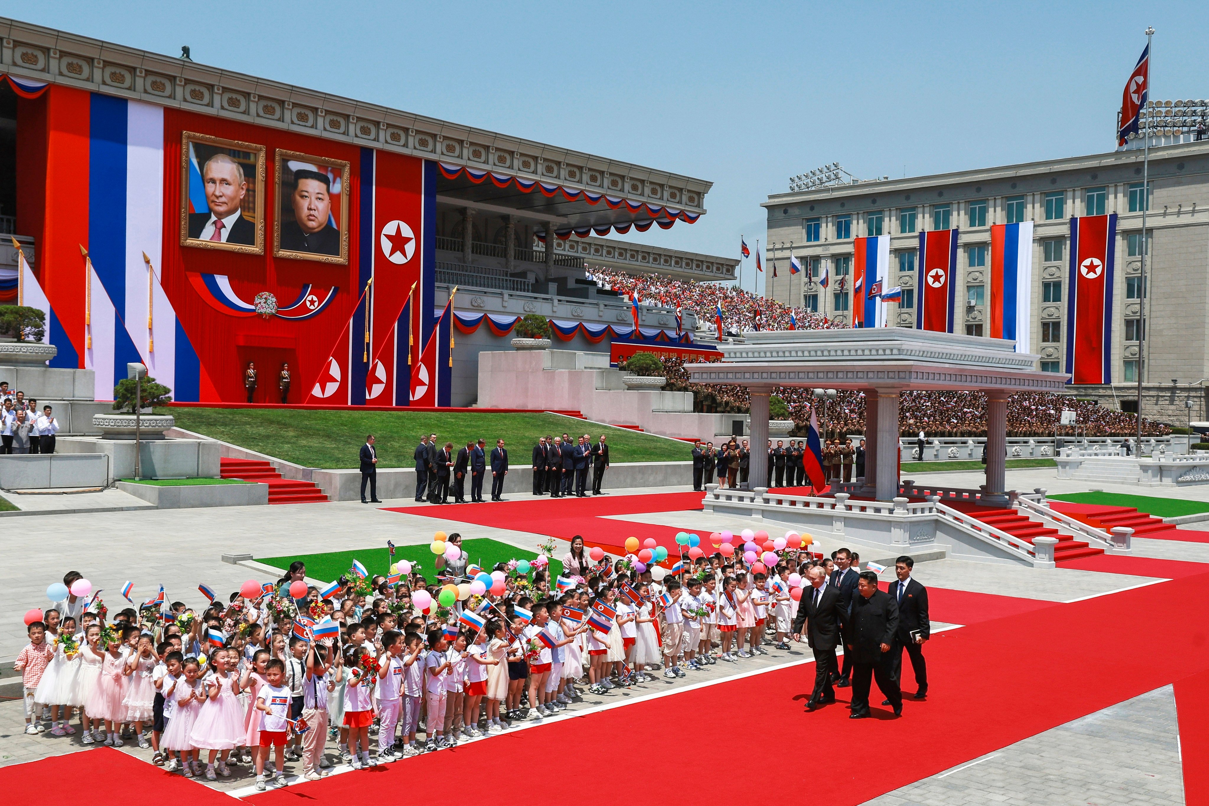 Russian President Vladimir Putin (left) and North Korea’s leader Kim Jong-un (foreground right) attend an official welcome ceremony for Putin in the Kim Il Sung Square in Pyongyang, North Korea, on June 19. China appears to be keeping its distance as Russia and North Korea move closer to each other with a new defence pact that could tilt the balance of power in Northeast Asia. Photo: AP