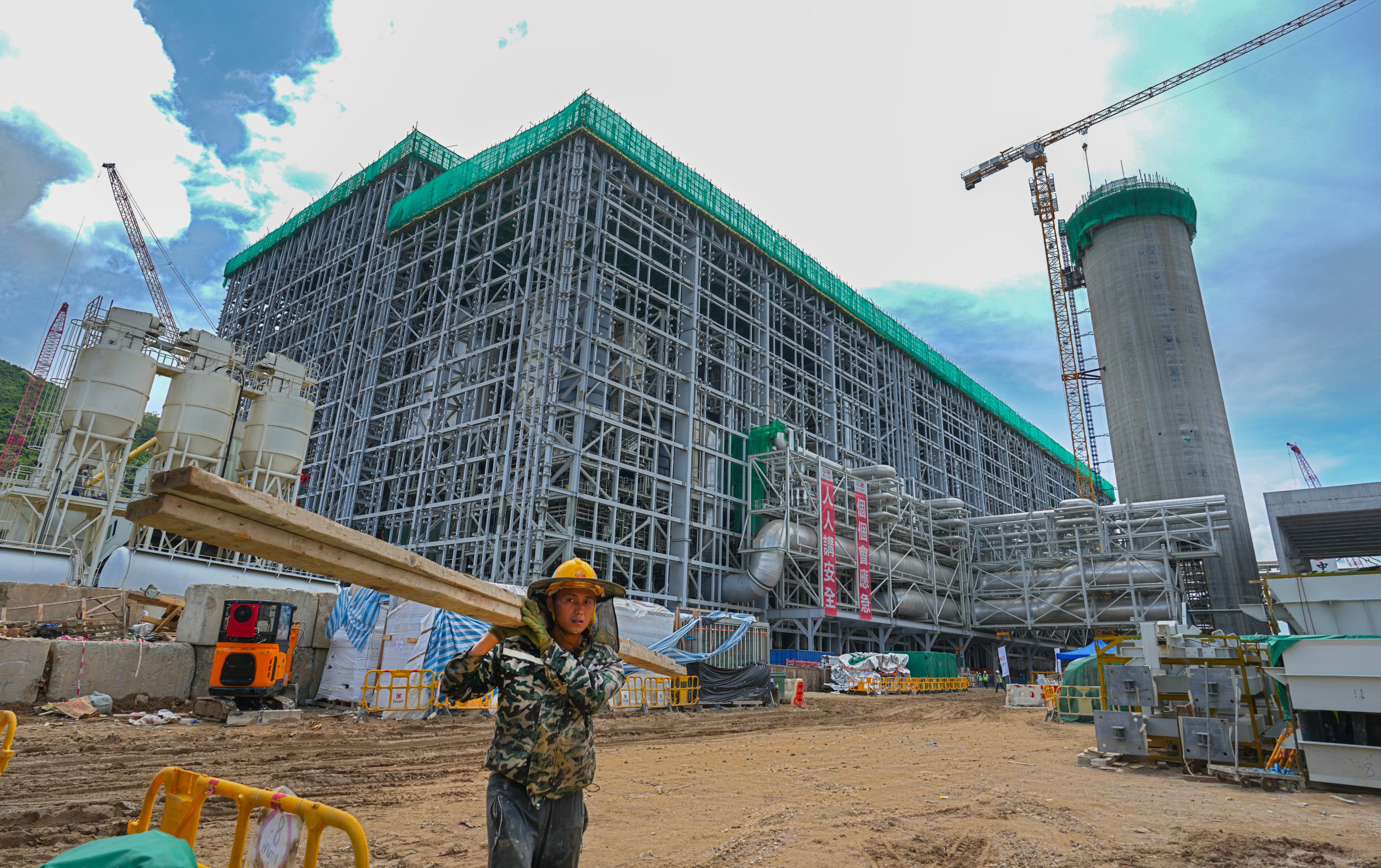 On June 19, a worker moves equipment at the construction site of I·PARK1, Hong Kong’s first waste-to-energy facility for treating municipal solid waste. Getting the hardware ready is the easy part. The more difficult challenge is to get households to sort waste properly for combustion and recycling. Photo: Sam Tsang