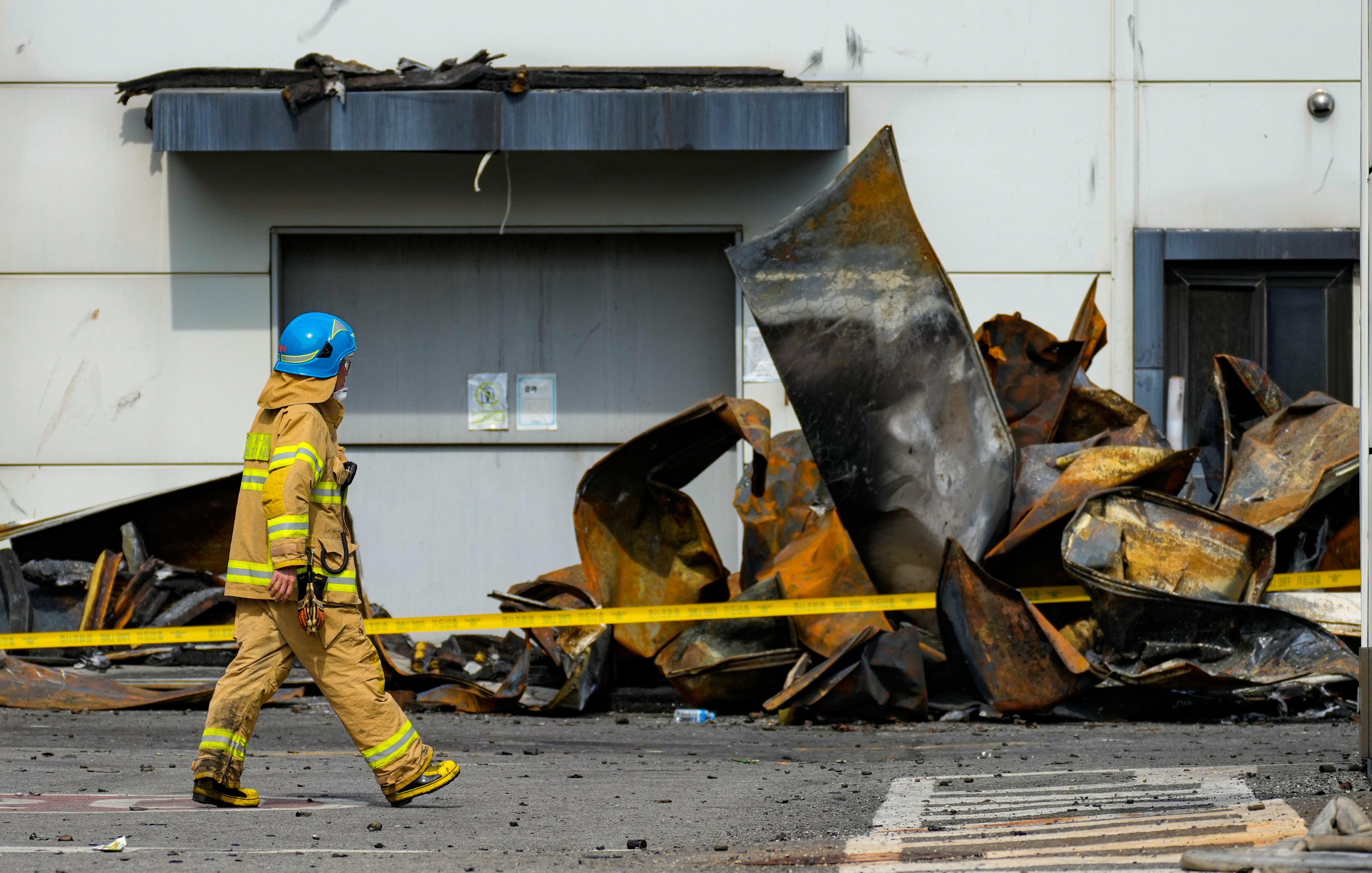 On Tuesday, Korean rescue workers were combing through the charred ruins of a factory building near South Korea’s capital, a day after a devastating blaze likely triggered by exploding lithium batteries killed 23 people, mostly Chinese migrant workers. Photo: AP