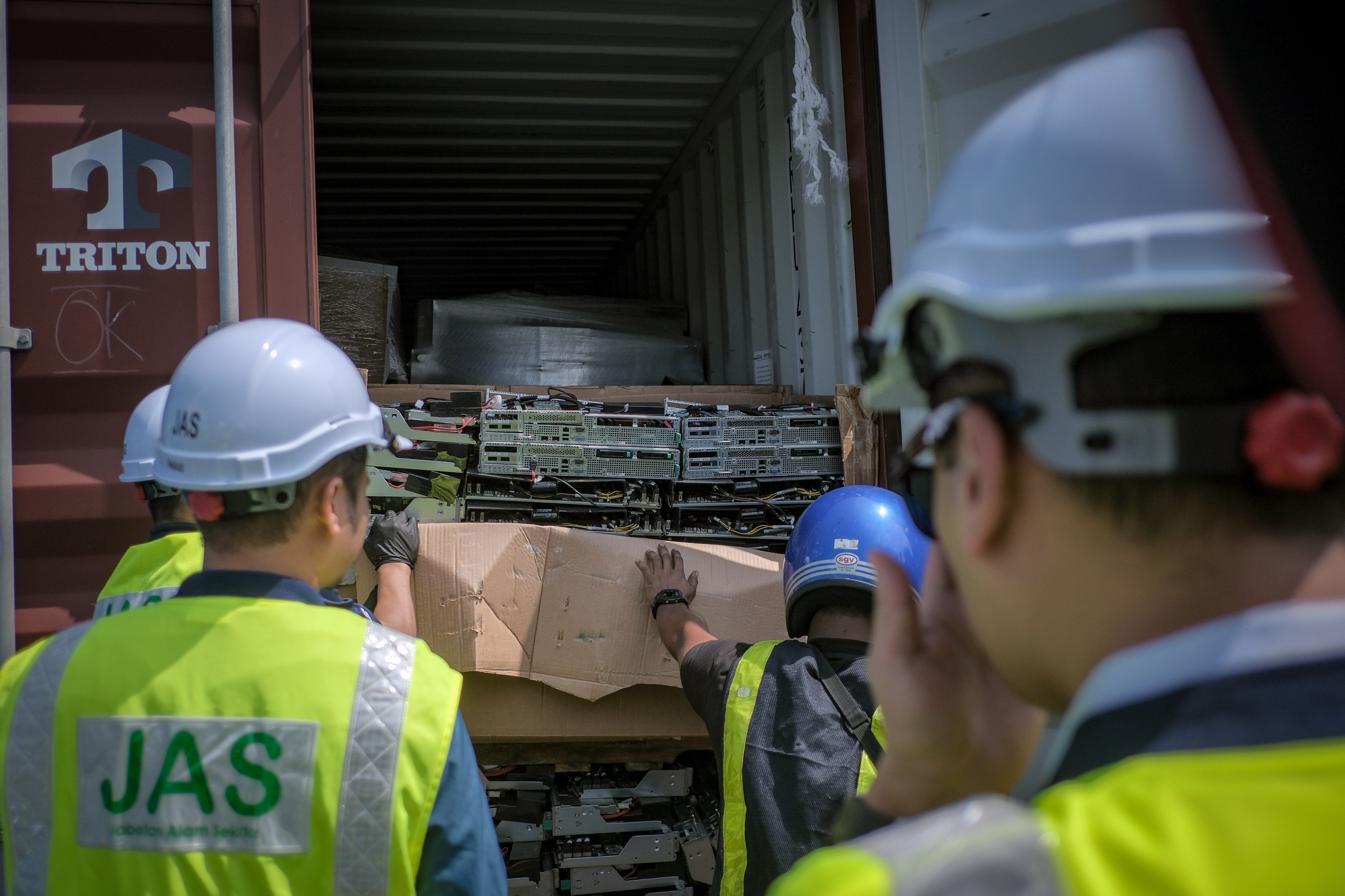 Malaysian officials examine a seized container filled with e-waste that originated from the Los Angeles port. Photo: Natural Resources and Environmental Sustainability Ministry