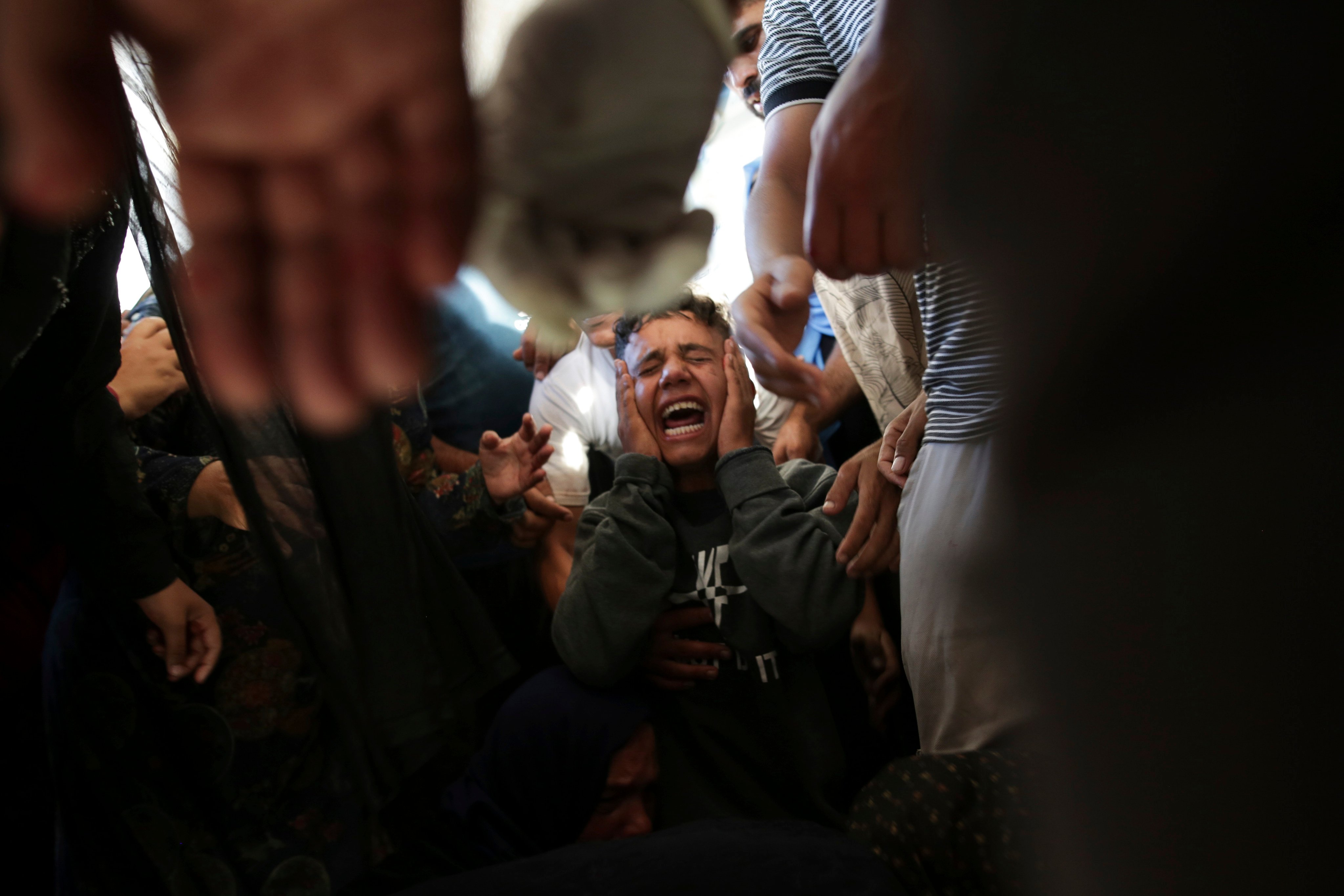 Palestinians at a hospital morgue in Khan Younis mourn relatives killed in an Israeli bombardment of the Gaza Strip. Photo: AFP