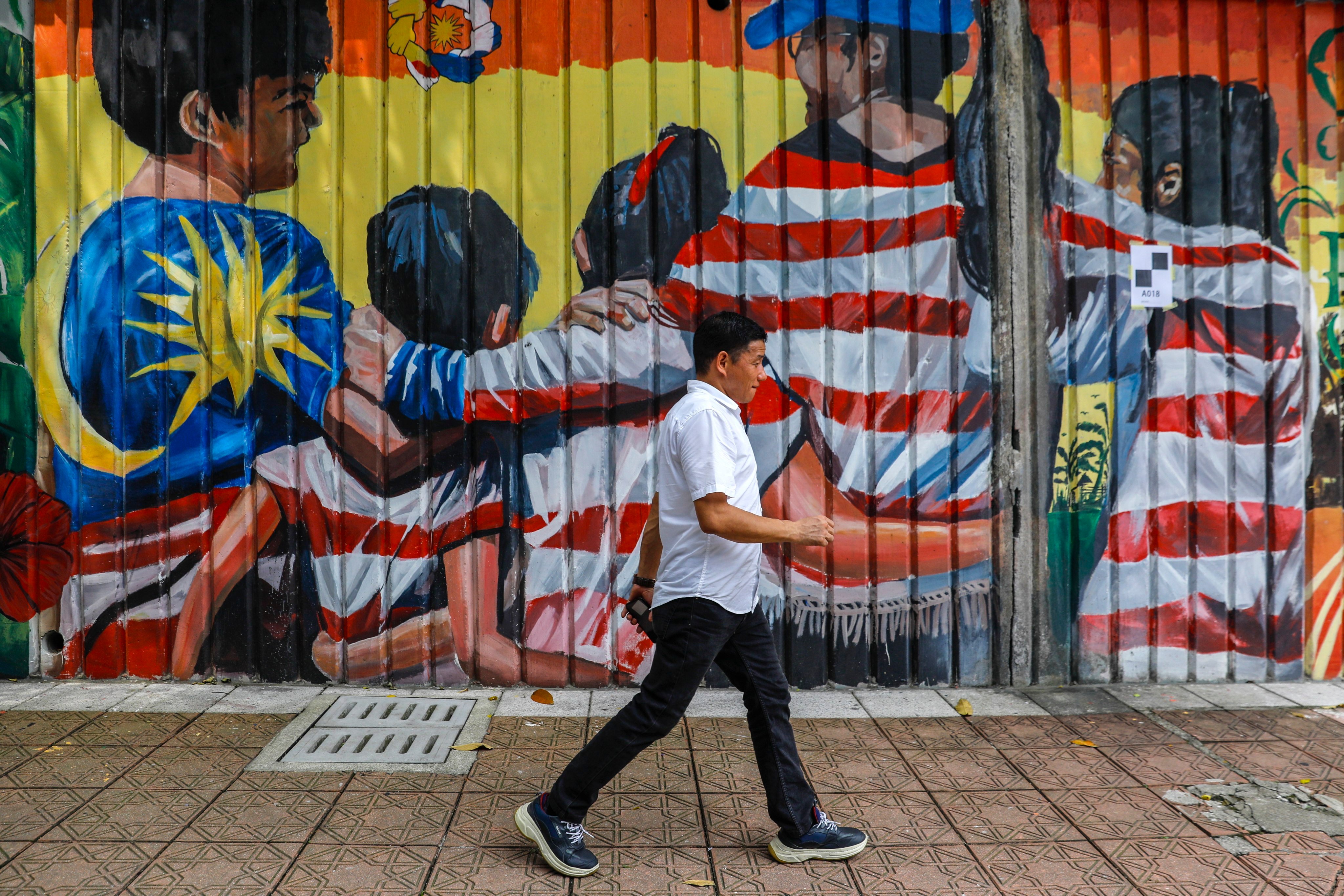 A pedestrian walks past a mural in Kuala Lumpur, Malaysia on June 1, 2023. While Malaysia has expressed support for joining Brics, it maintains close ties with the United States. Photo: EPA-EFE
