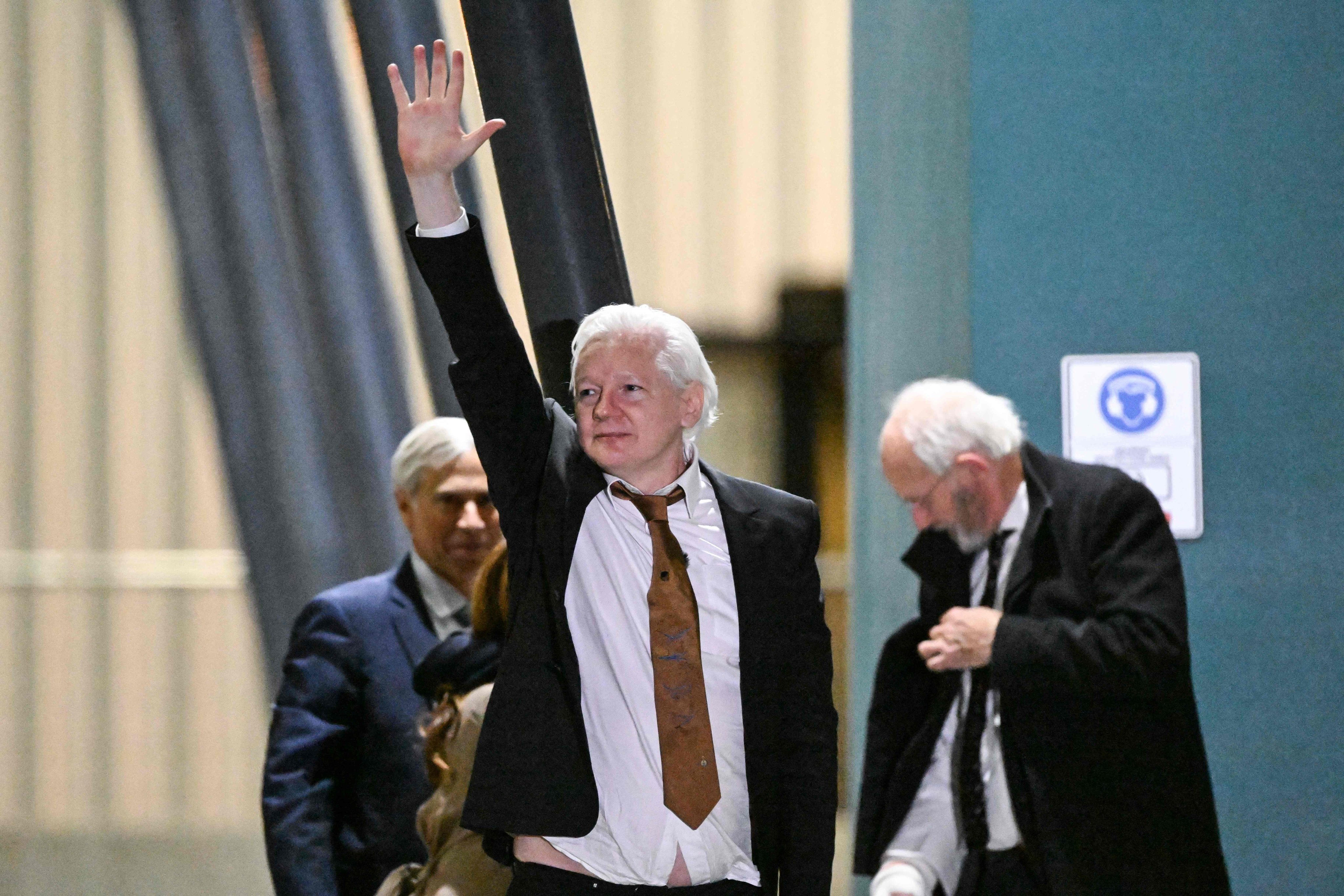 WikiLeaks founder Julian Assange waves after arriving at Canberra Airport in Canberra on Wednesday. Photo: AFP