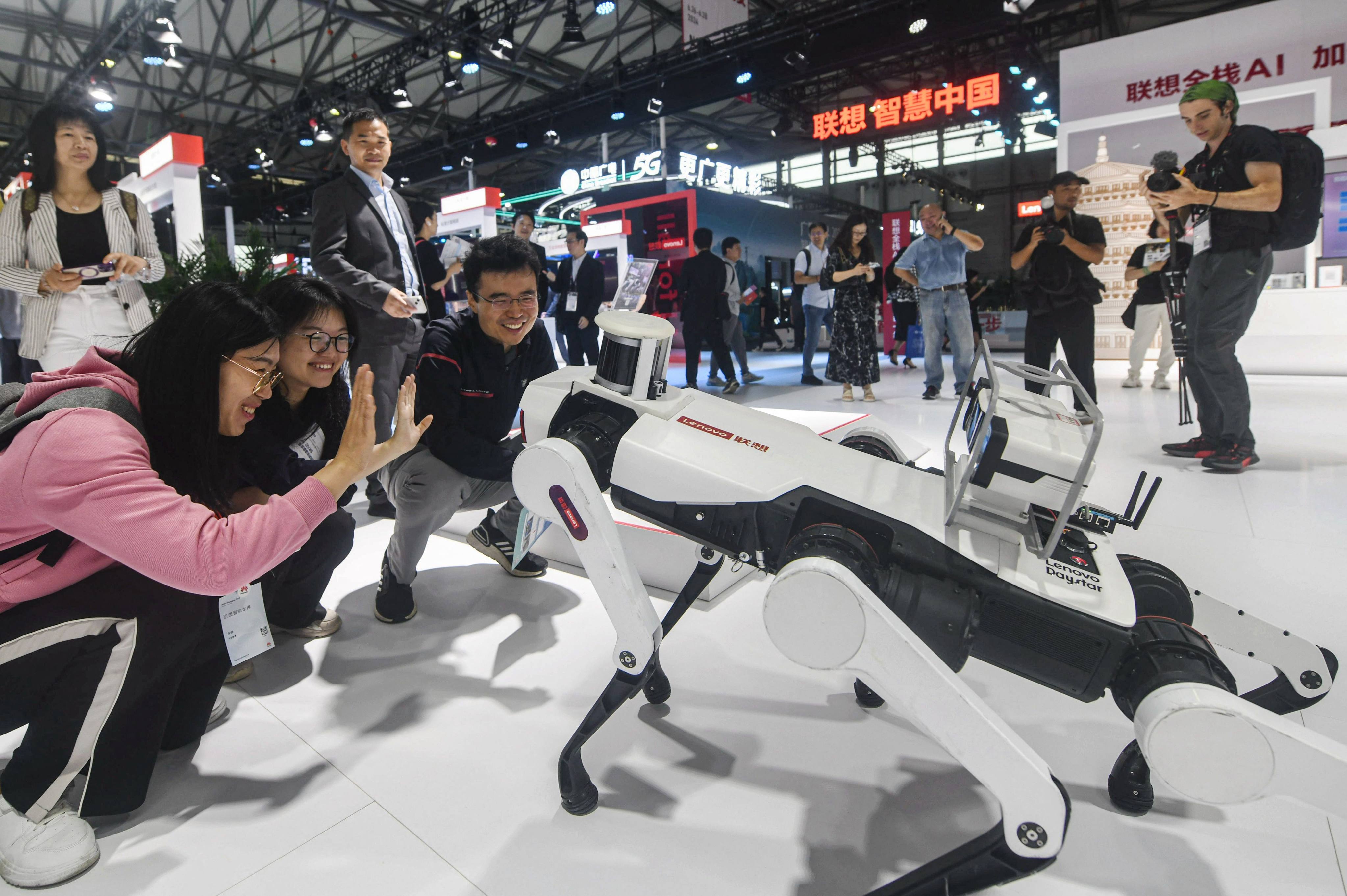 Visitors interact with Lenovo Group’s robot at the opening of the MWC Shanghai trade show on June 26, 2024. Photo: AFP