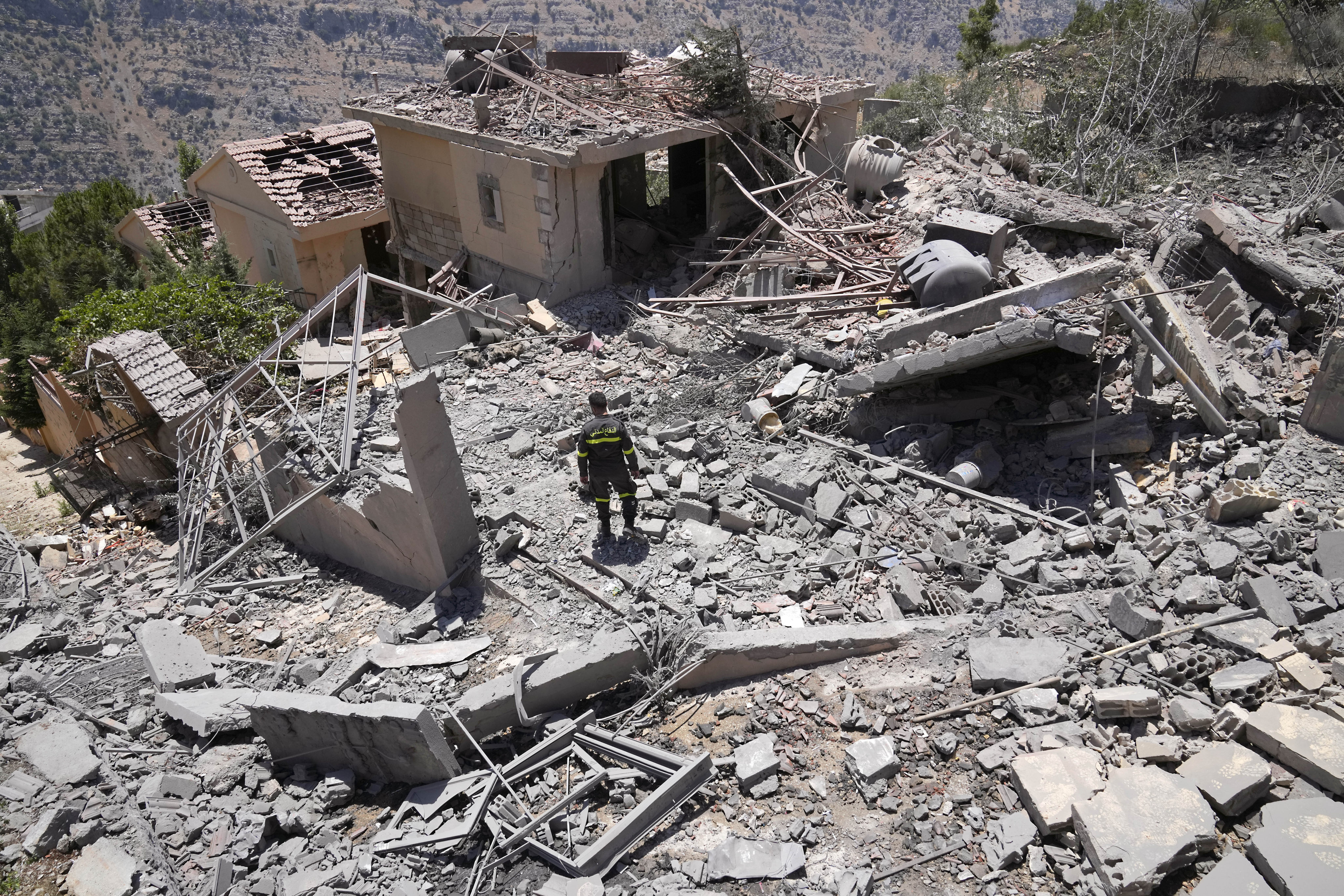 A civil defence worker inspects a destroyed house that was hit by an Israeli air strike, in Chebaa, a Lebanese town. Photo: AP
