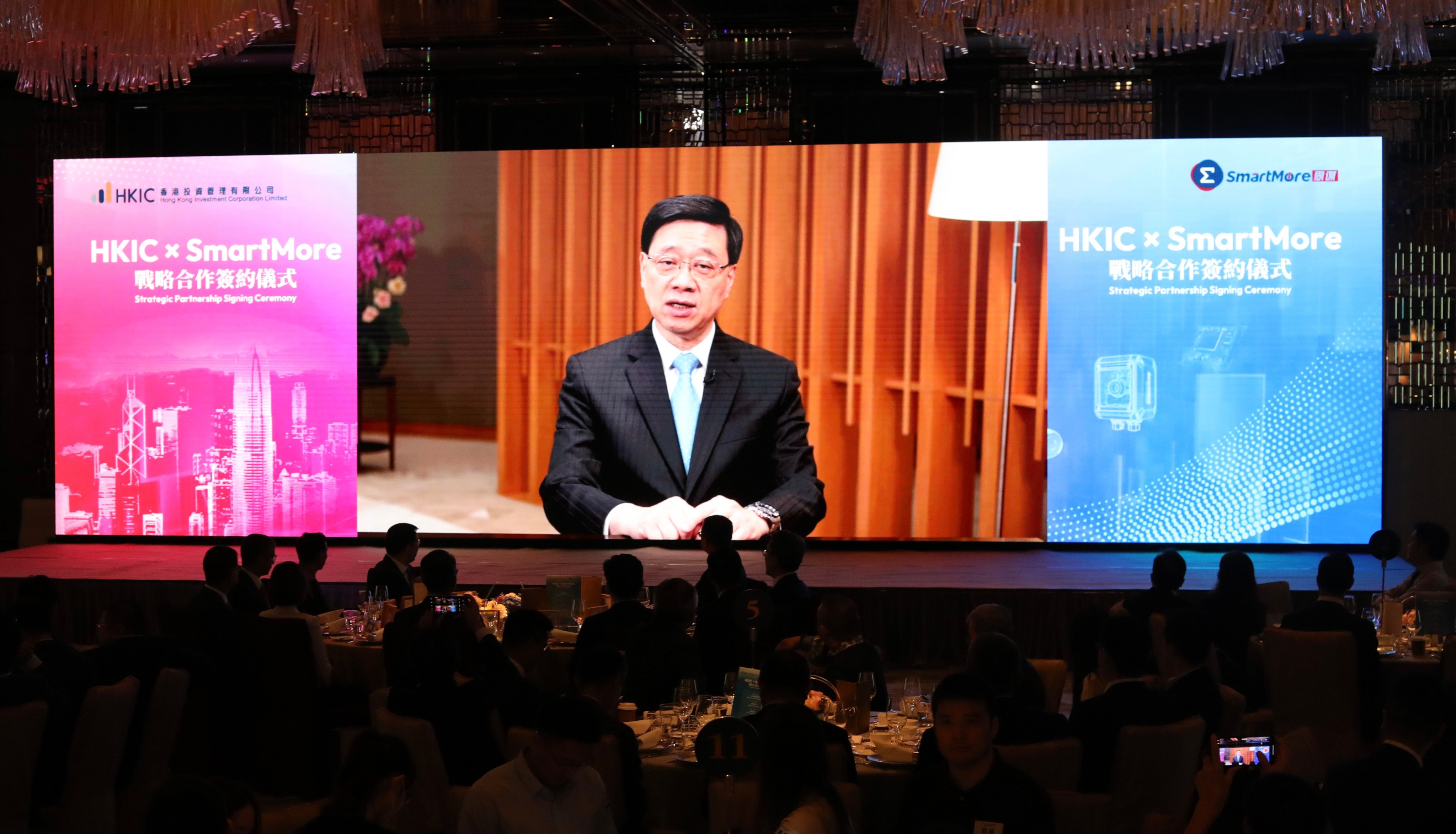 Chief Executive John Lee delivers a video message during the strategic partnership signing ceremony between Hong Kong Investment Corporation and Smartmore on June 12. Photo: Sun Yeung