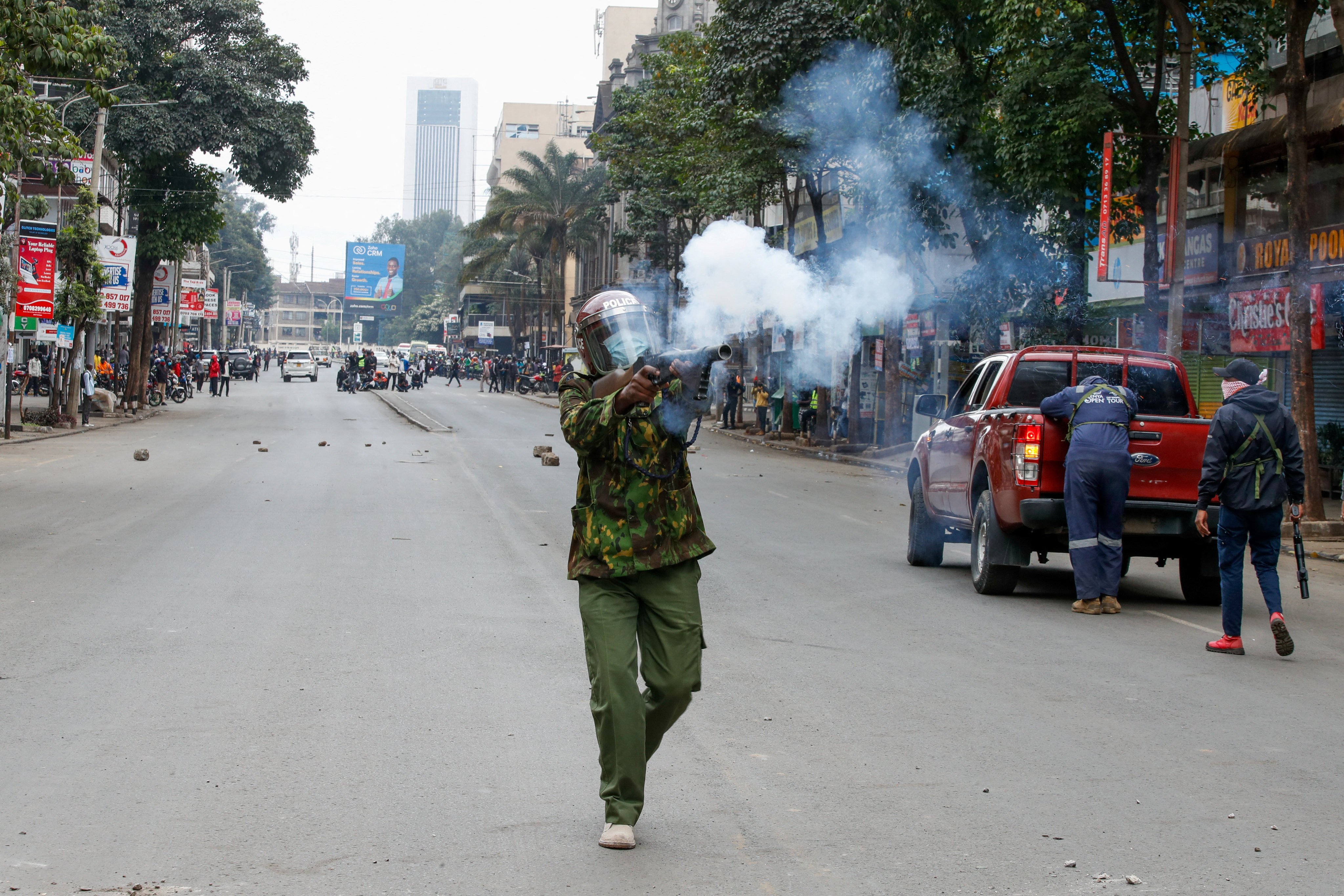 A police member fires tear gas at a demonstration over police killings of people protesting against Kenya’s proposed finance bill on Thursday. Photo: Reuters