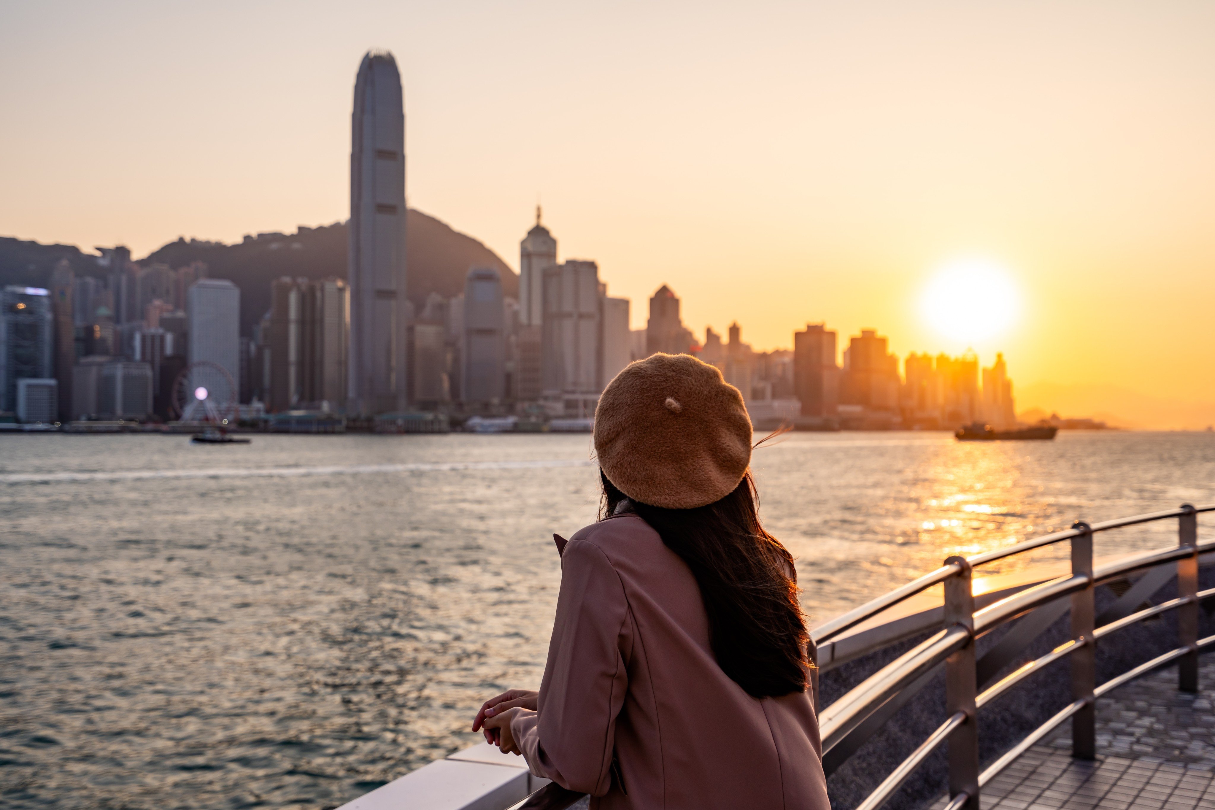 A traveller gazes upon Victoria Harbour at sunset. As a gateway to mainland China, Hong Kong has the potential to capture more tourists seeking authentic and immersive travel experiences. Photo: Shutterstock 