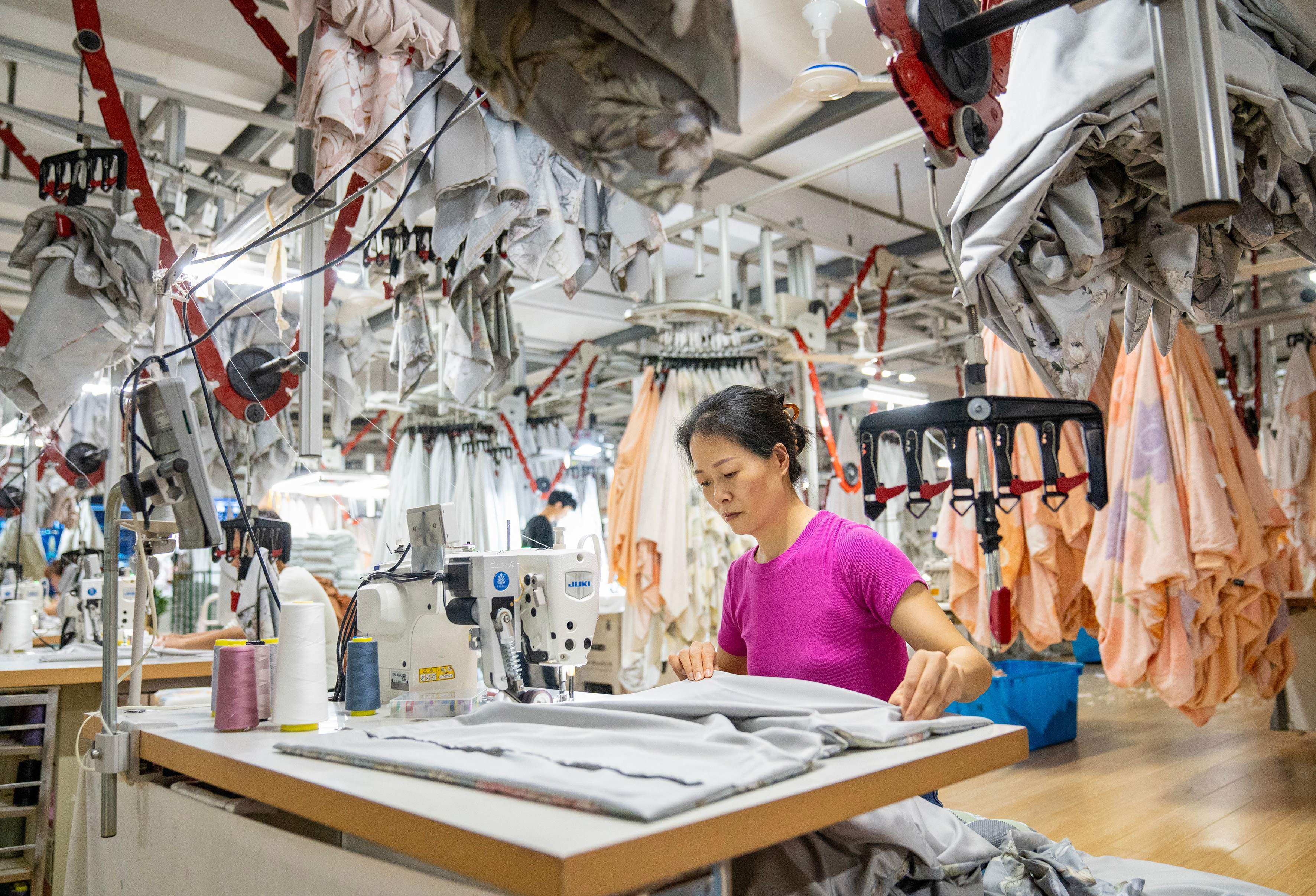 An employee works at a textile factory in Nantong, in eastern Jiangsu province, on June 25. Sentiment towards China’s economy has improved this year amid signs of economic stabilisation and more forceful stimulus measures. Photo: AFP