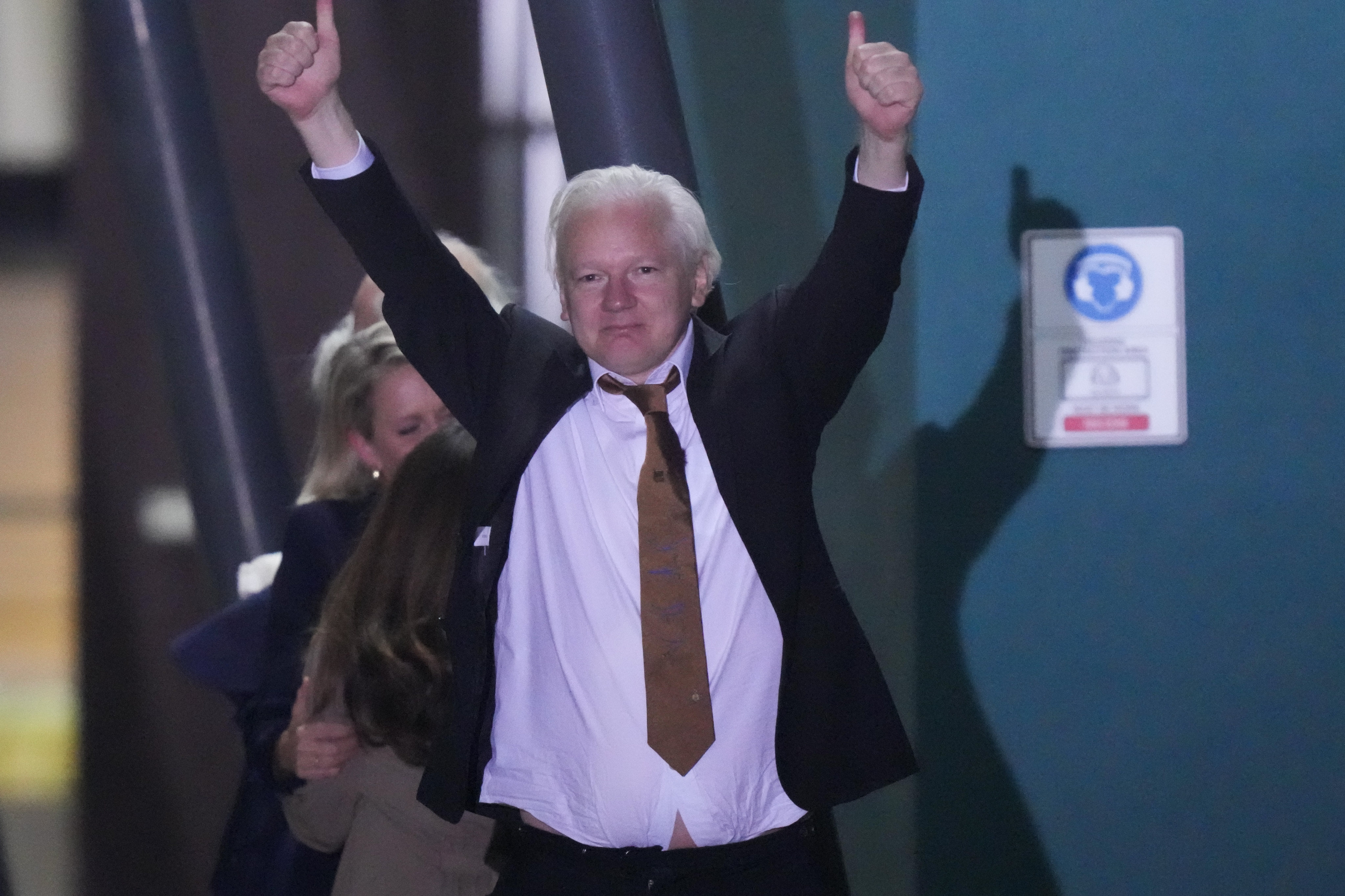 WikiLeaks founder Julian Assange gestures after landing at an air base in Canberra, Australia, on June 26. Photo: AP