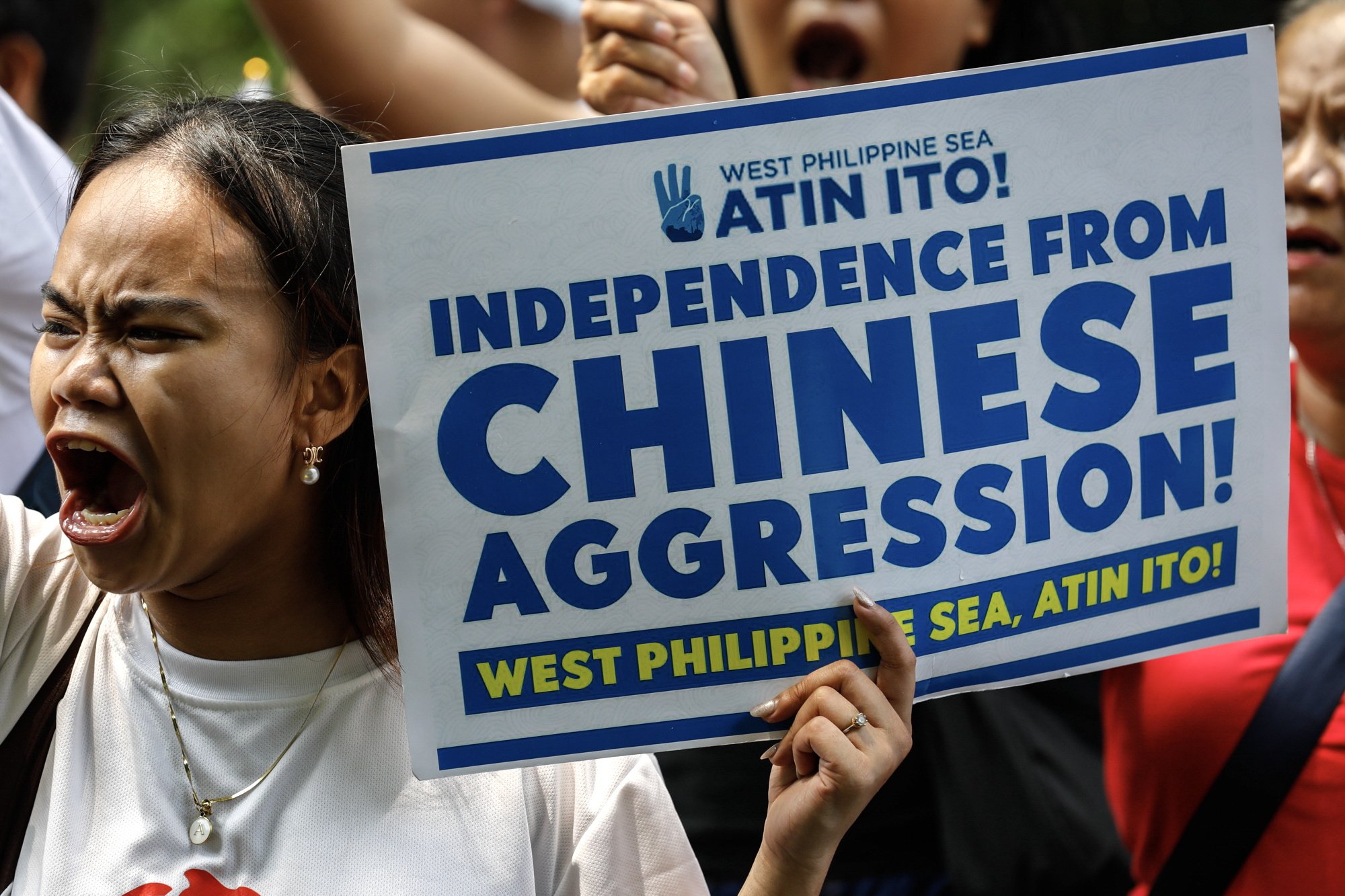 A protester chants slogans while holding a sign criticising China’s alleged harassment toward Philippine contingents in disputed waters of the South China Sea. Photo: EPA-EFE/ROLEX DELA PENA