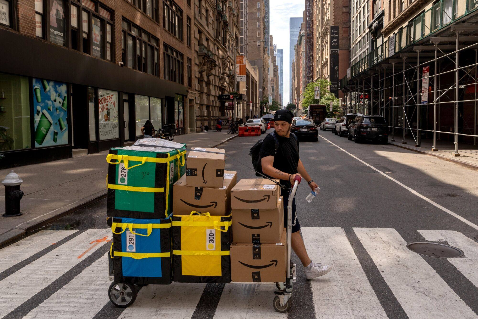A delivery worker moves Amazon packages in New York. Photo: Bloomberg