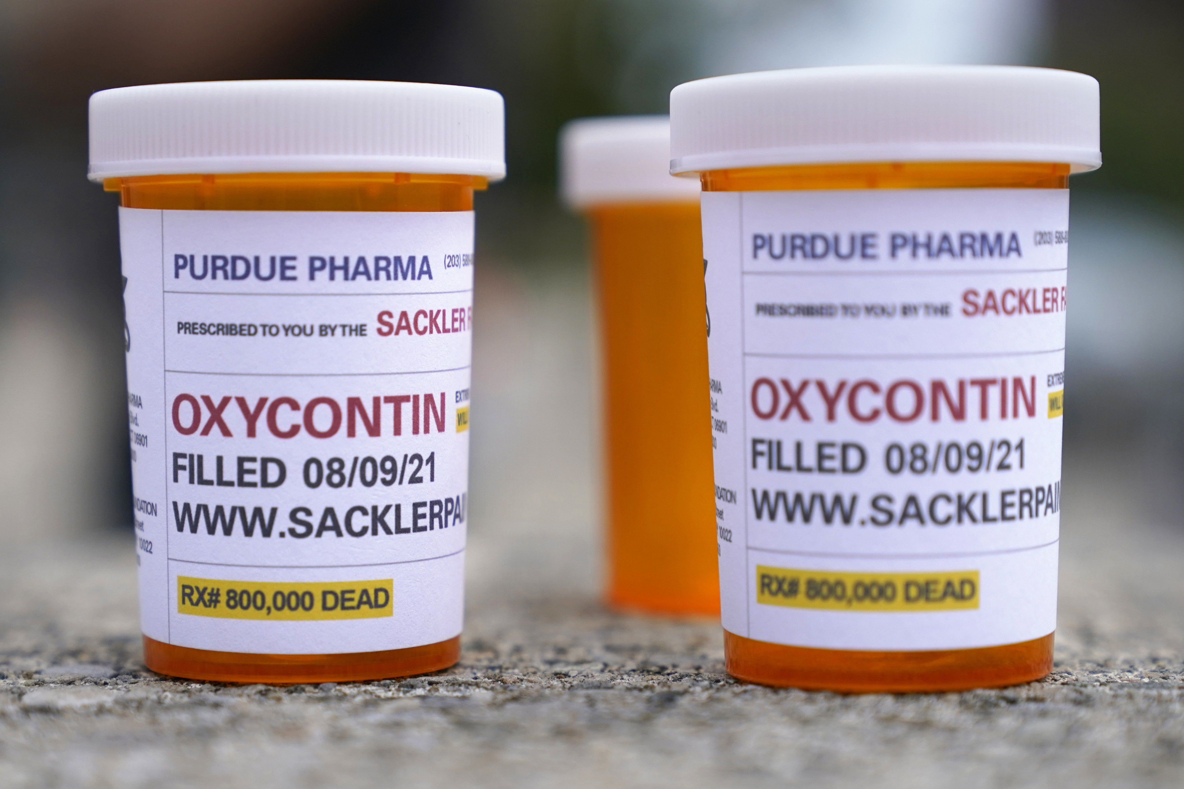 Fake pill bottles with messages about OxyContin maker Purdue Pharma are displayed during a protest outside the courthouse where the company’s 2021 bankruptcy occurred. The US Supreme Court has rejected a settlement with OxyContin maker Purdue Pharma that would have shielded members of the Sackler family from civil lawsuits. Photo: AP