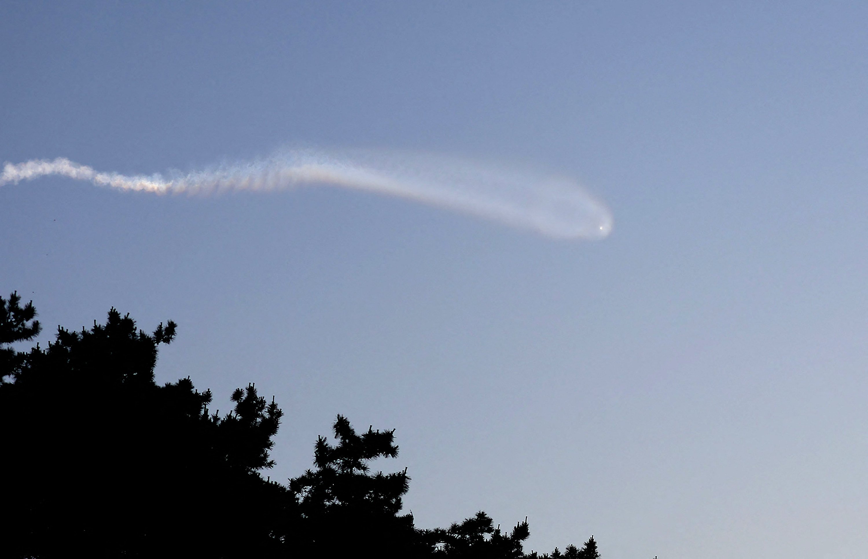 A vapour trail believed to be created by a North Korean missile is seen from Yeonpyeong island, South Korea, on June 26. Photo: Yonhap/AFP