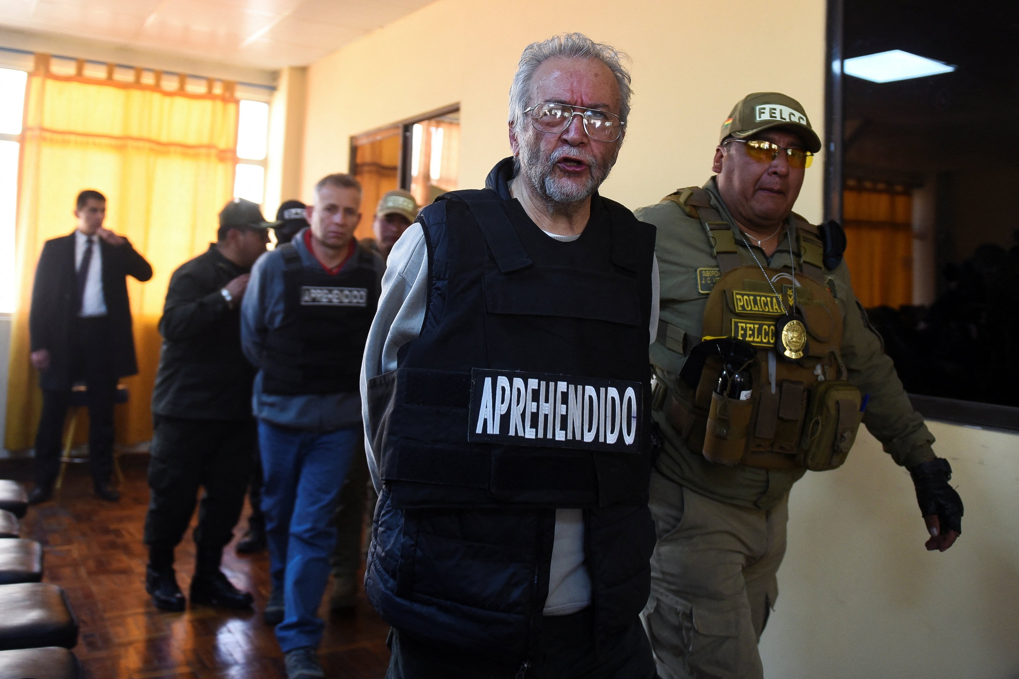 Detained military officer Abel Anibal Aguilar is escorted during a press conference in La Paz, Bolivia, on Thursday. Photo: Reuters
