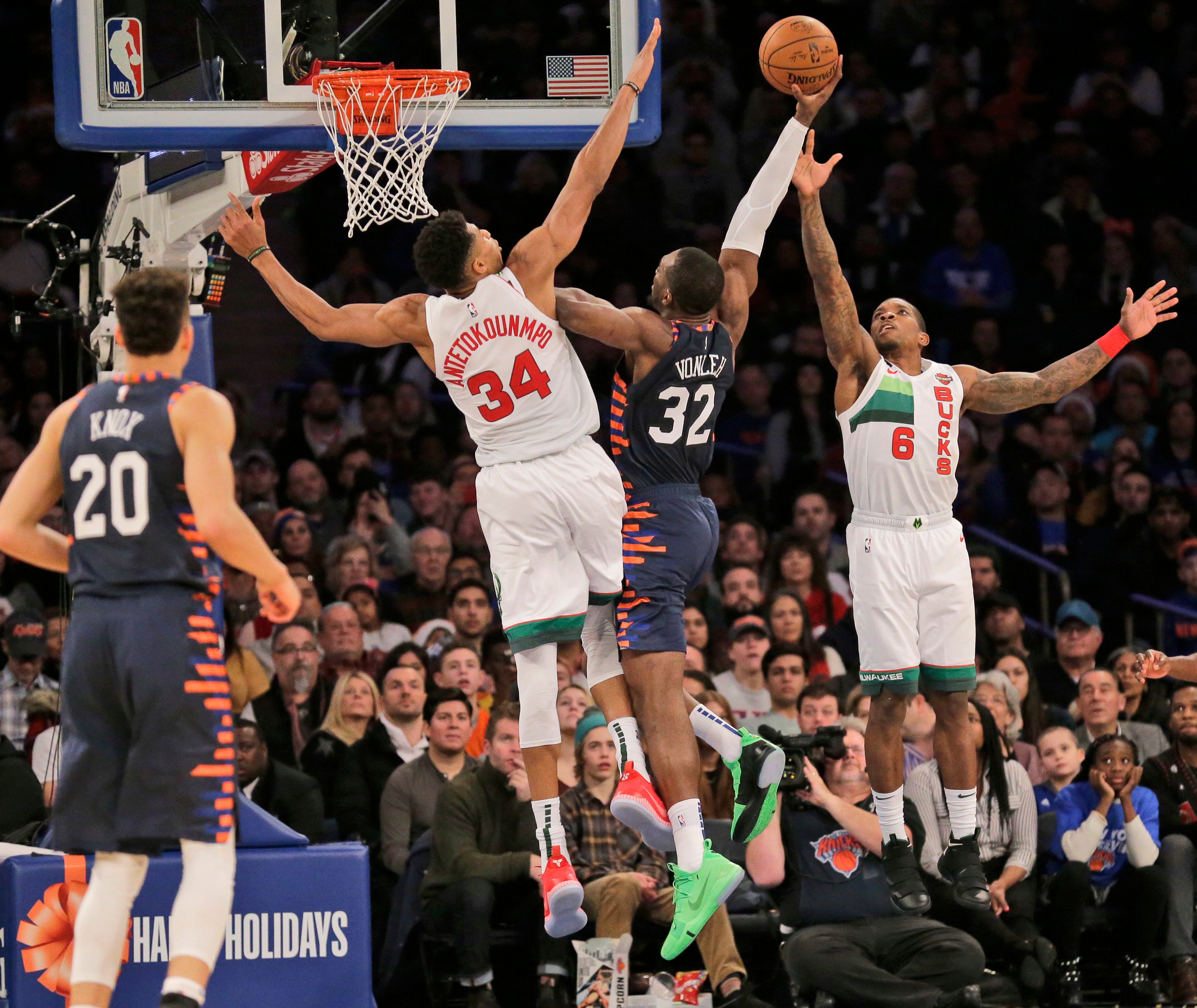 New York Knicks’ Noah Vonleh (centre), is defended by Milwaukee Bucks’ Eric Bledsoe and Giannis Antetokounmpo during the second half of an NBA game. Photo: AP