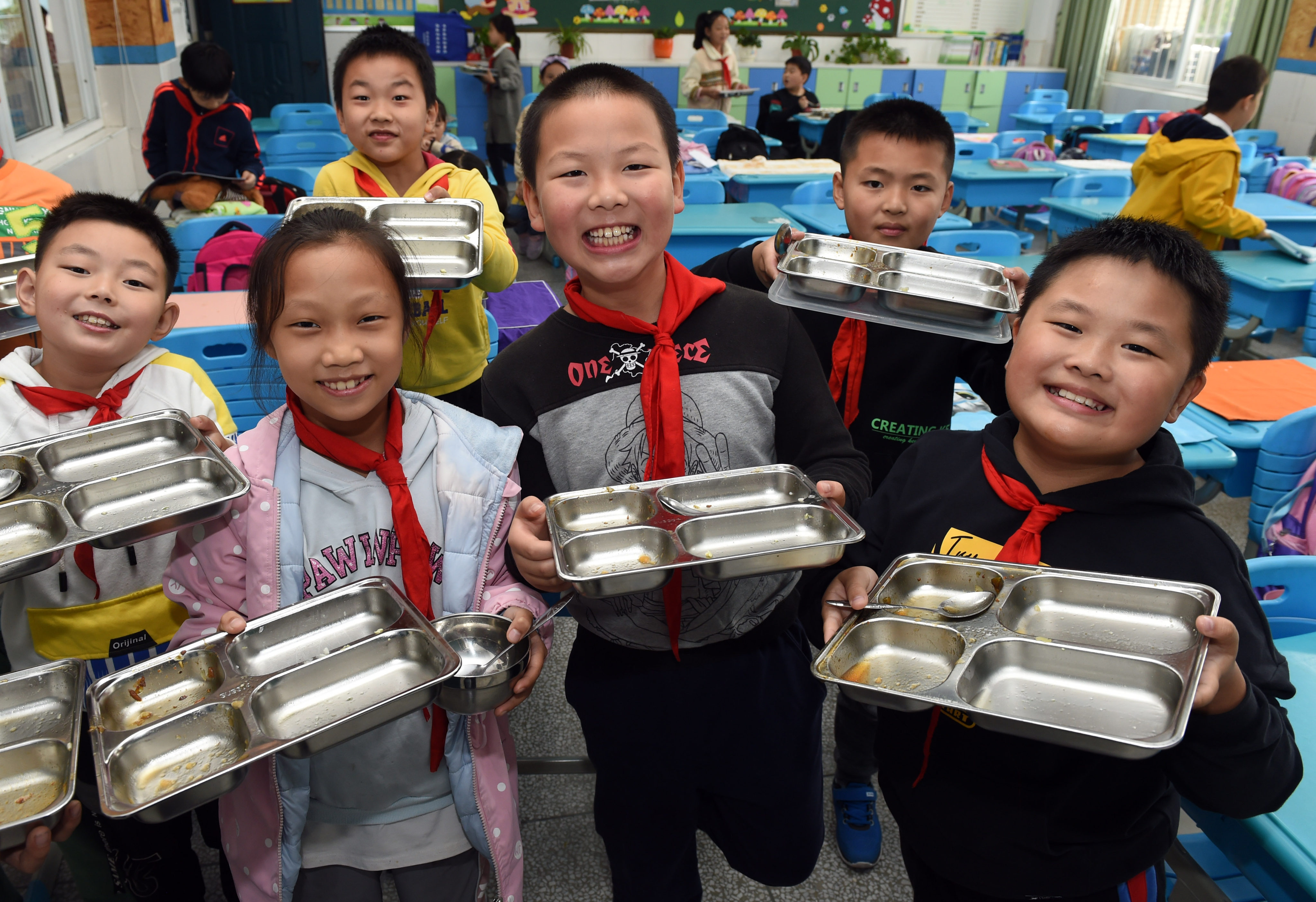 Providing meals at school in poorer areas have been shown to improve not only nutrition levels but cognitive abilities, academic performance and class enrolment rates as well. China introduced its rural school meal plan in 2011. Photo: Xinhua