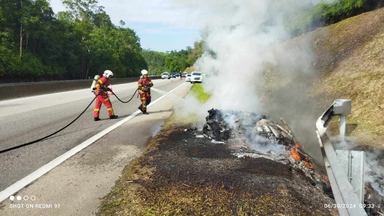 Firefighters extinguish a blaze that fully engulfed a Lamborghini on a highway in Malaysia. Photo: Facebook/BombaBentong
