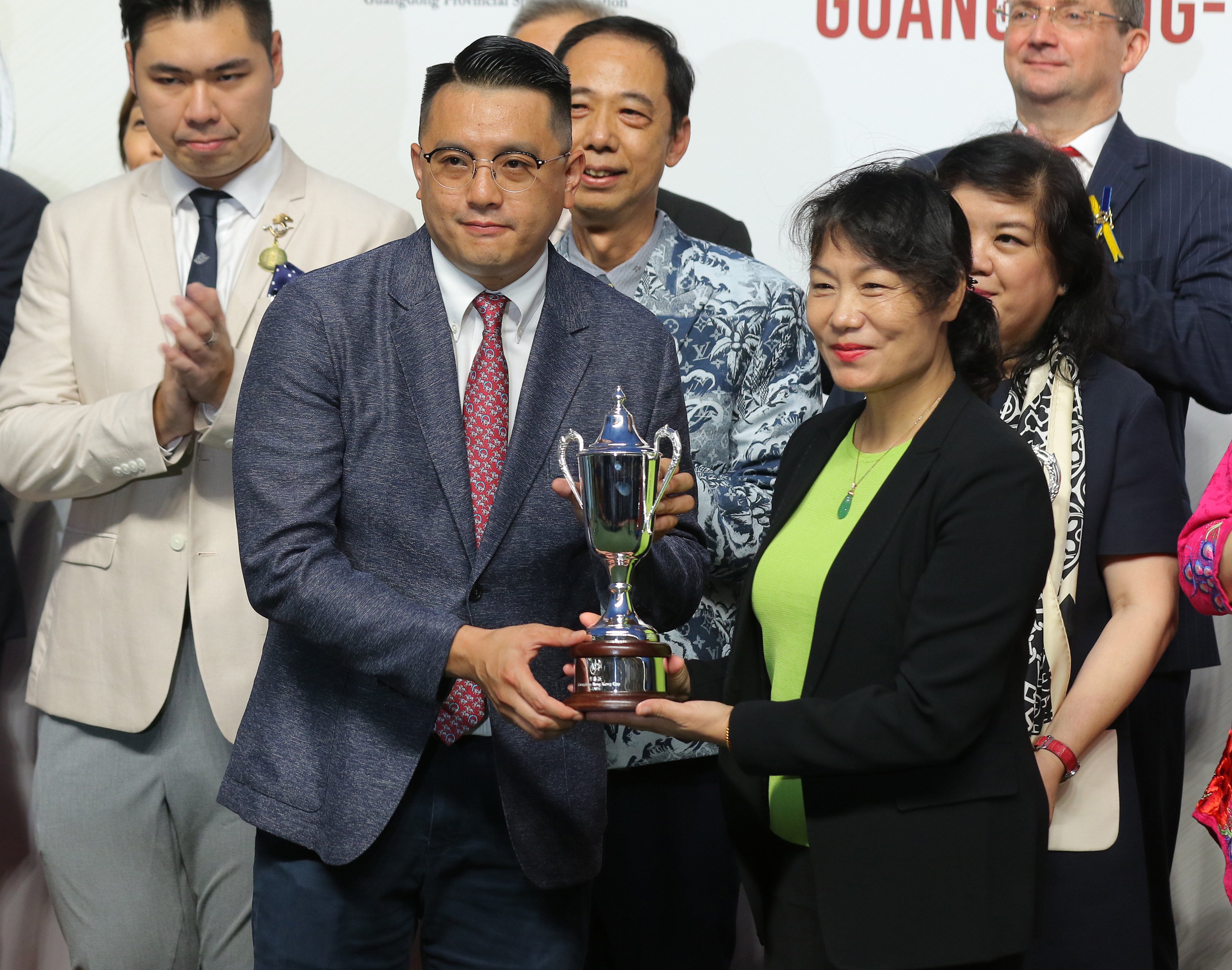 Pierre Ng collects the Guangdong-Hong Kong Cup after Super Bonus’ tough win at Sha Tin. Photos: Kenneth Chan