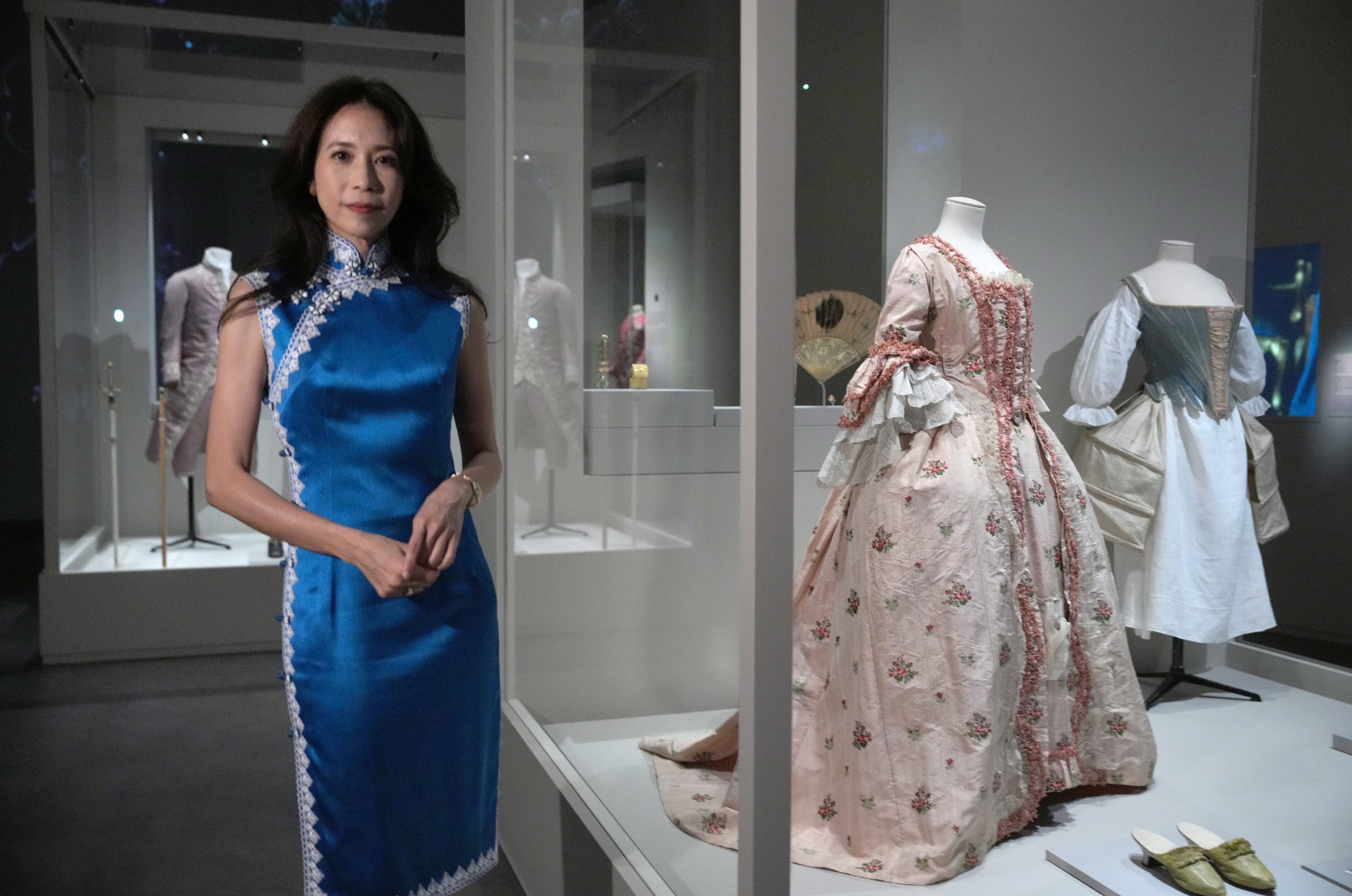 Singer and actress Karen Mok, who narrated the audio guide for the exhibition, poses with a French silk dress dating back to about 1770 at “The Adorned Body: French Fashion and Jewellery 1770–1910” at the Hong Kong Palace Museum. Photo: May Tse