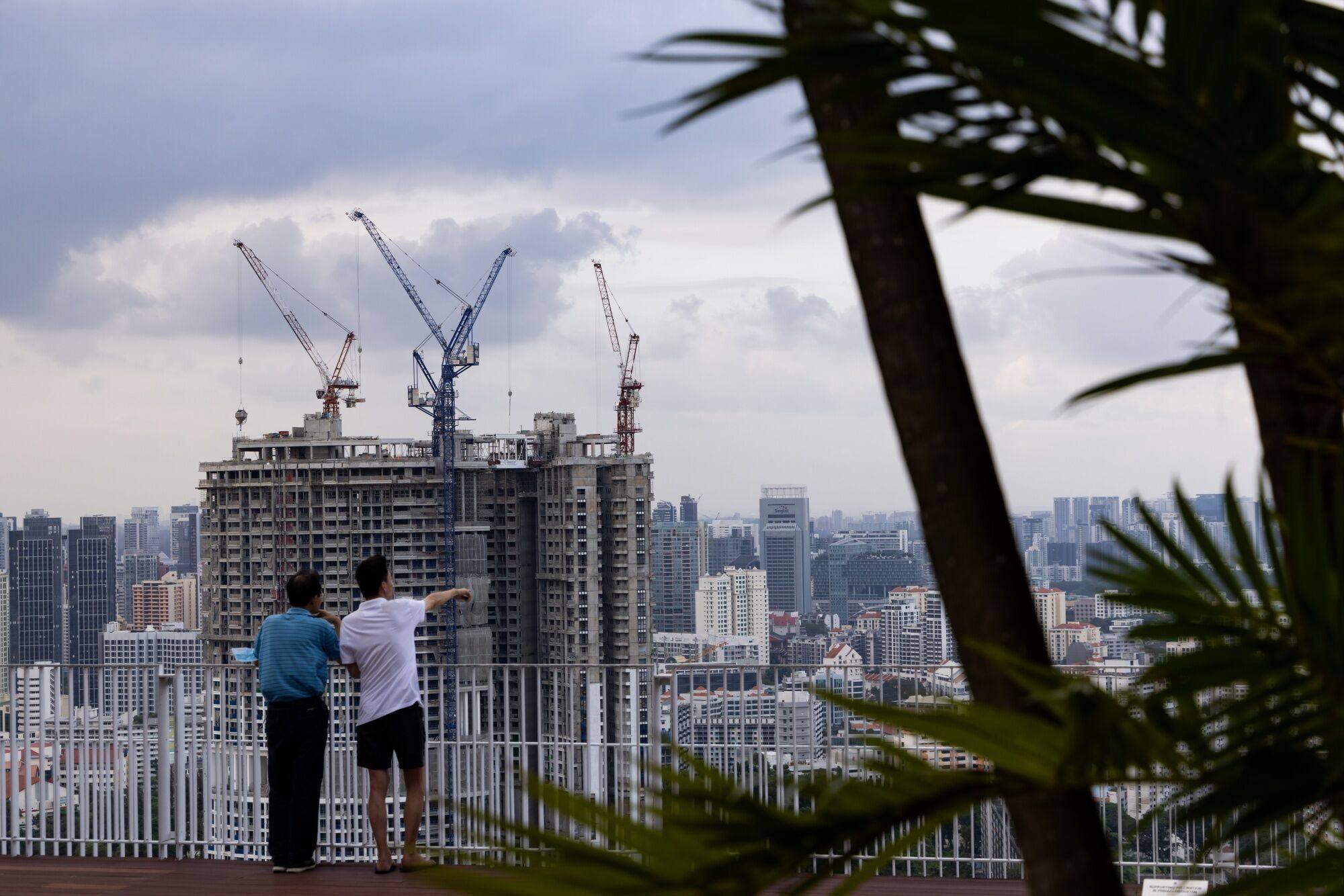 People look at buildings under construction in Singapore on February 17. Rental growth has surged in the city state in recent years, driving residents’ concerns about the cost of living and housing affordability. Photo: Bloomberg