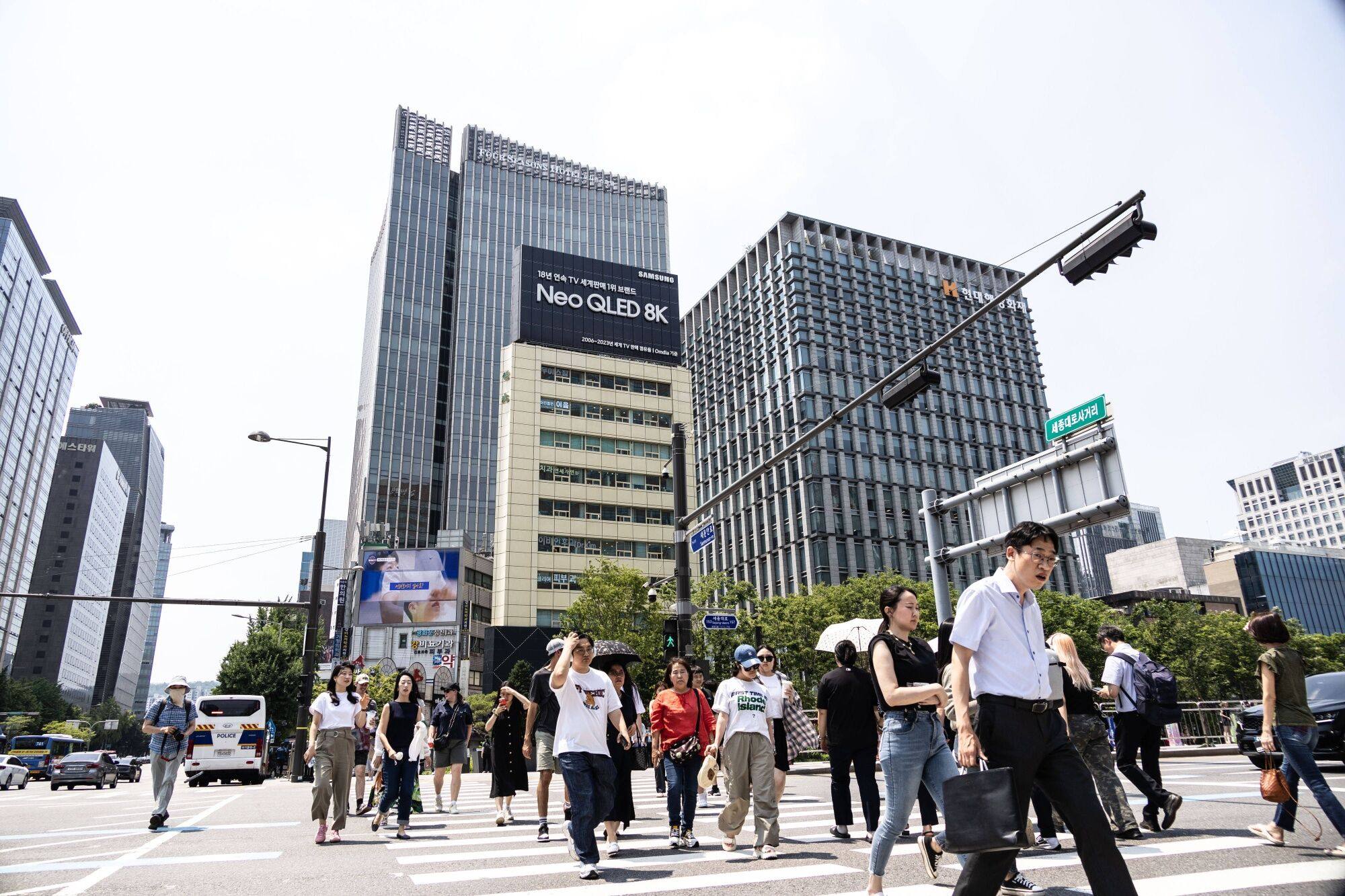 People cross a street in Seoul, South Korea, on Friday. Carmaker Renault Korea Motors is embroiled in a misandry backlash online sparked by promotional content. Photo: Bloomberg