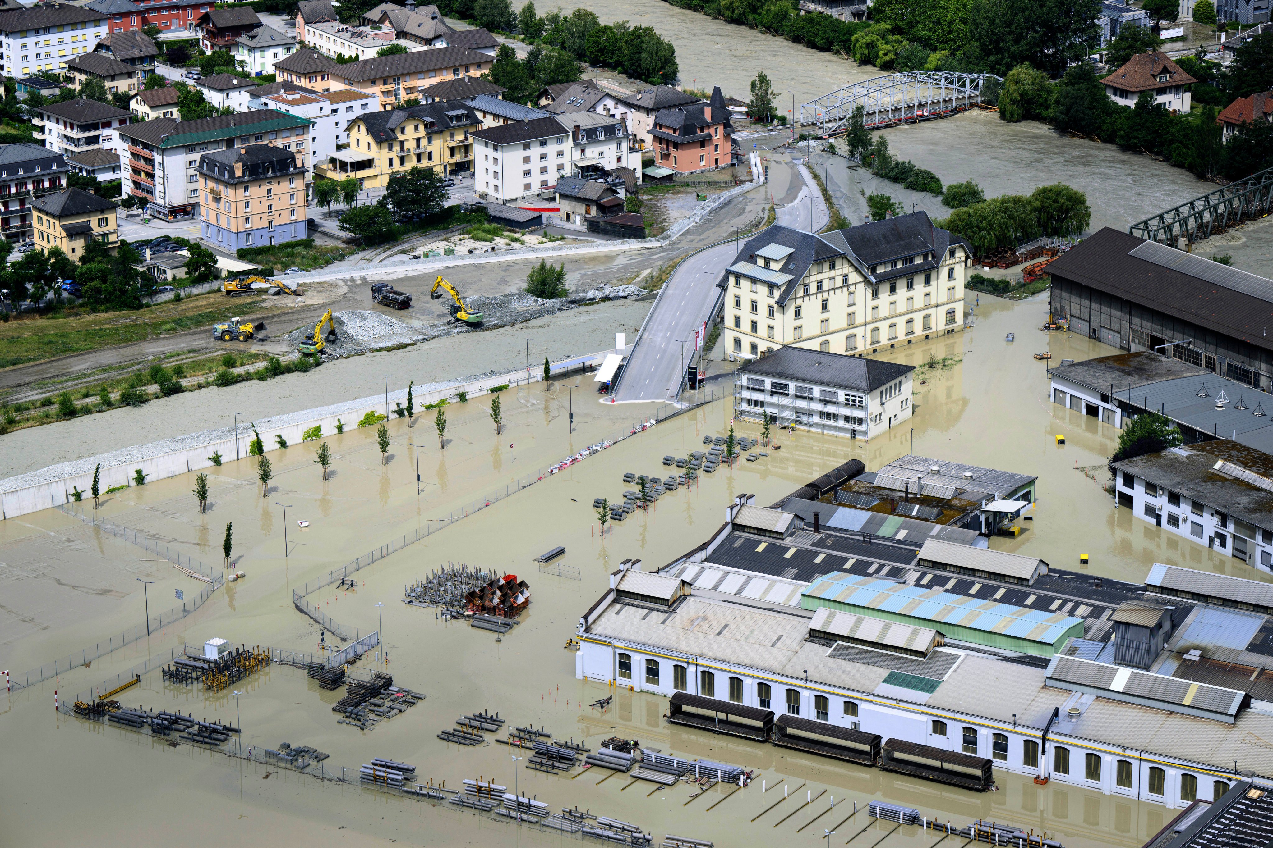 The Rhone river and the Navizence river, following the storms that caused major flooding, in Chippis, Switzerland. Photo: Jean-Christophe Bott/Keystone via AP