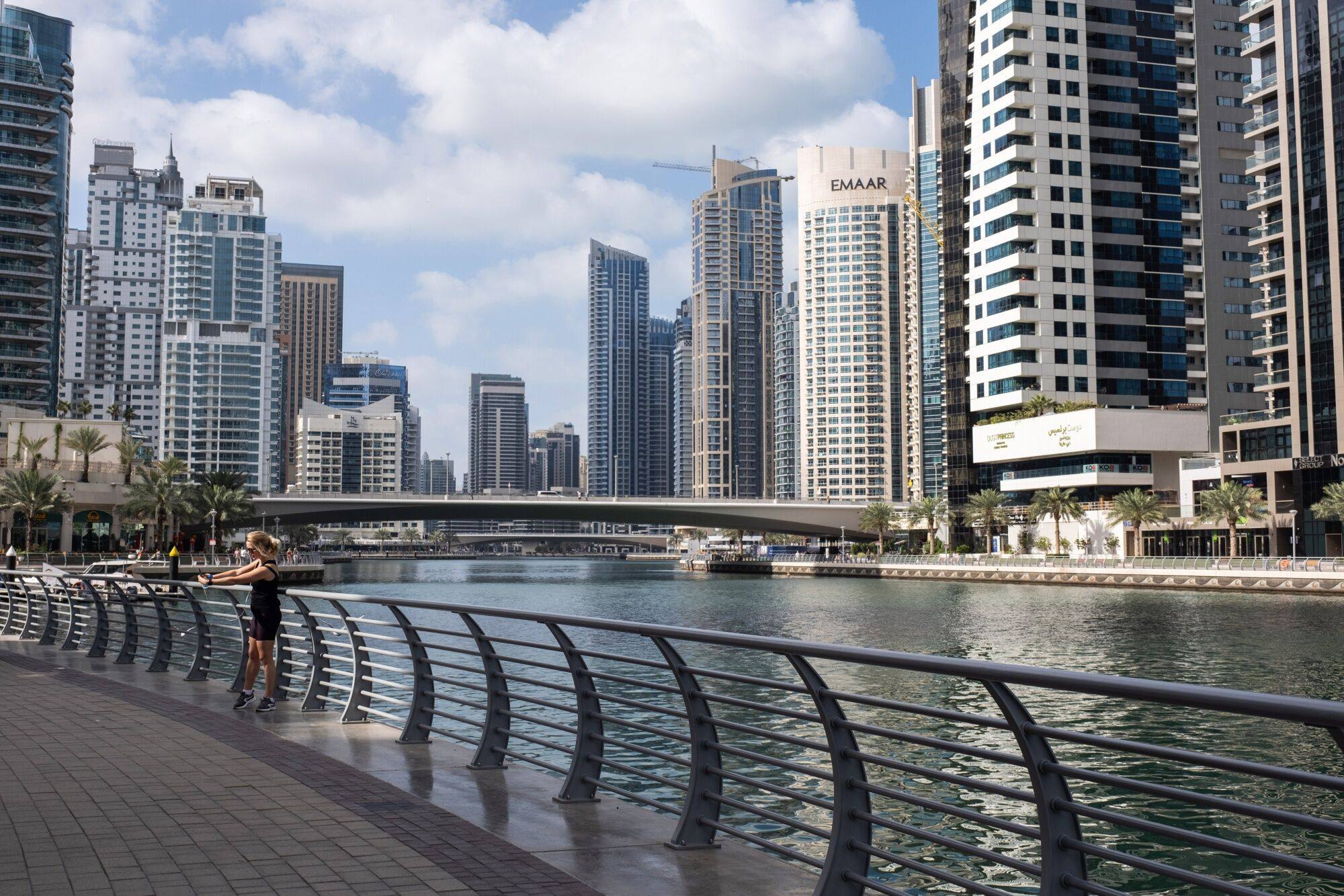 A runner pauses for a selfie in the Dubai Marina district of Dubai, United Arab Emirates, on February 19, 2024. Photo: Bloomberg