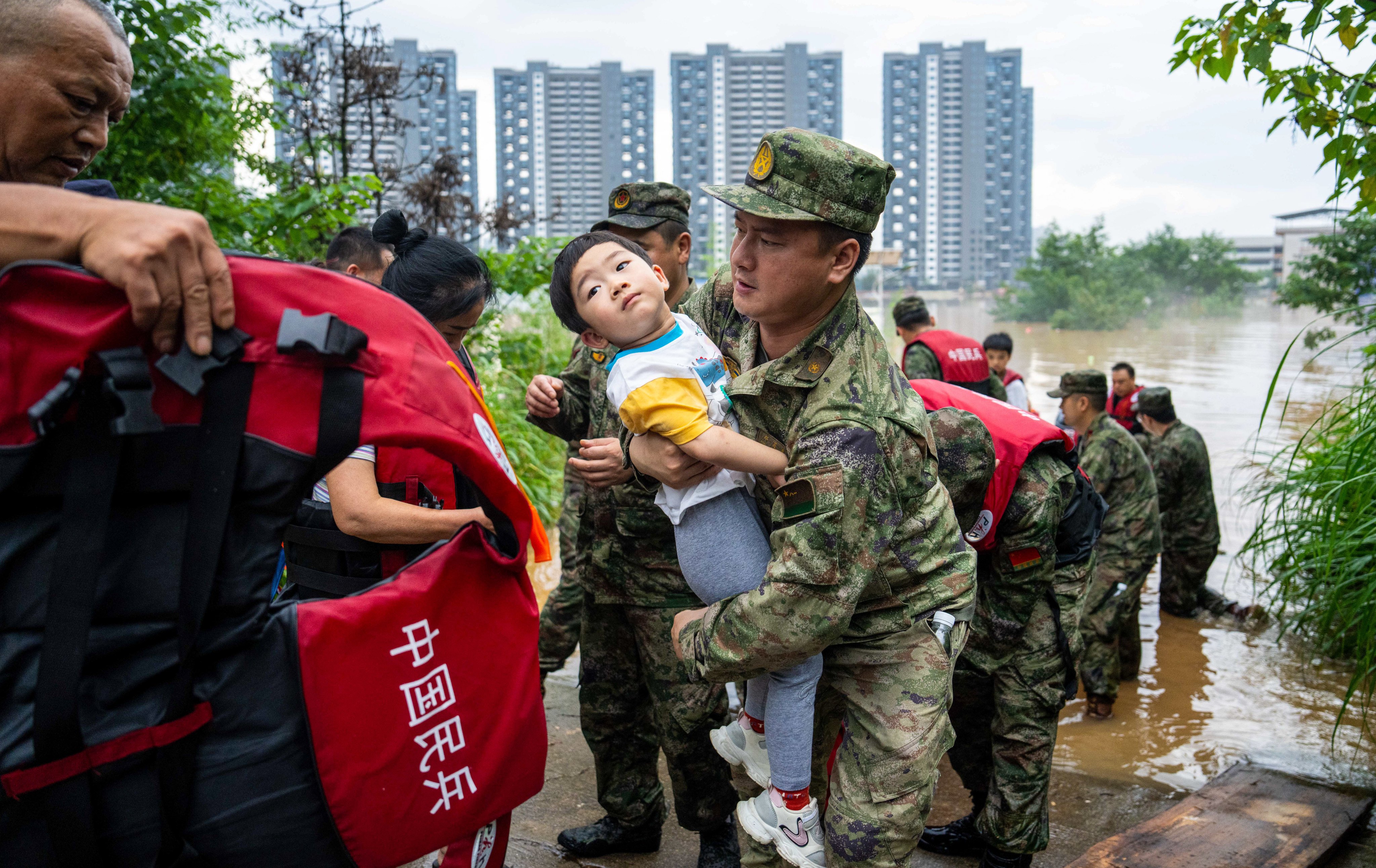 Residents are evacuated from a flooded village in Pingjiang county, Hunan province on Monday. Photo: Xinhua