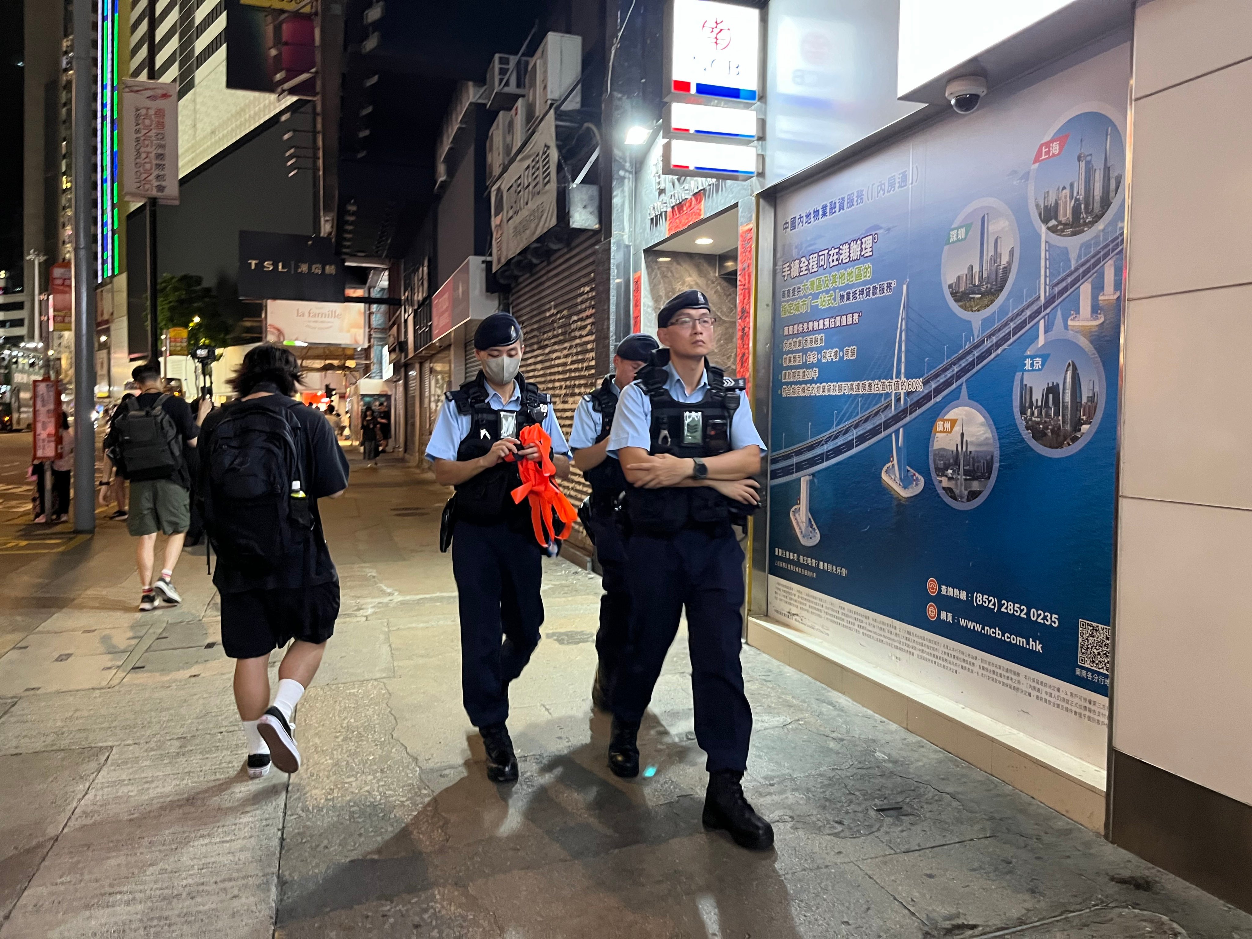 Police officers patrol the streets around Sogo on Monday evening. Photo: Emily Hung
