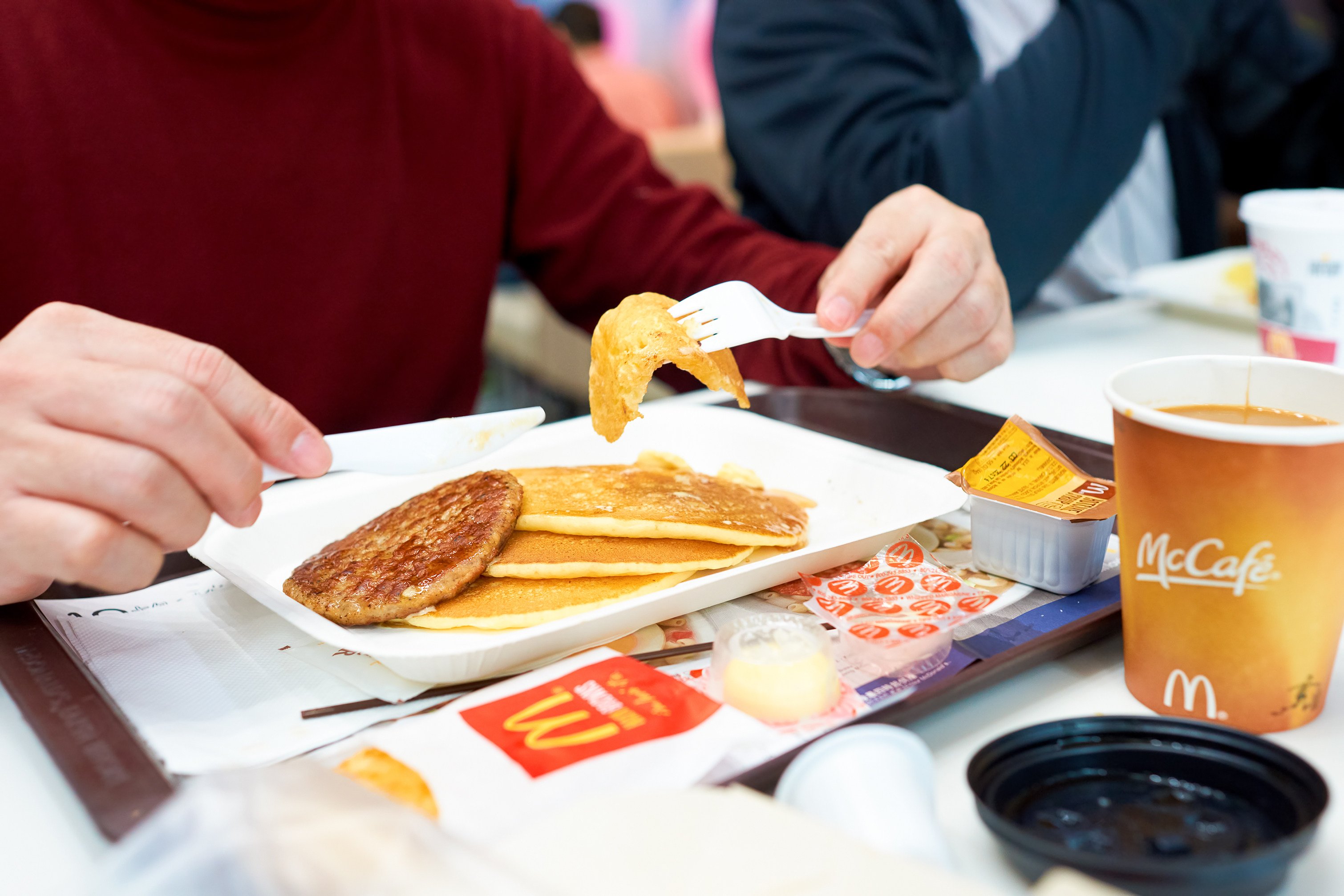 A man eat breakfast at a McDonald’s restaurant. McDonald’s Australia has cut breakfast service by 1-1/2 hours, after a shortage of eggs caused by bird flu outbreaks .Photo: Shutterstock