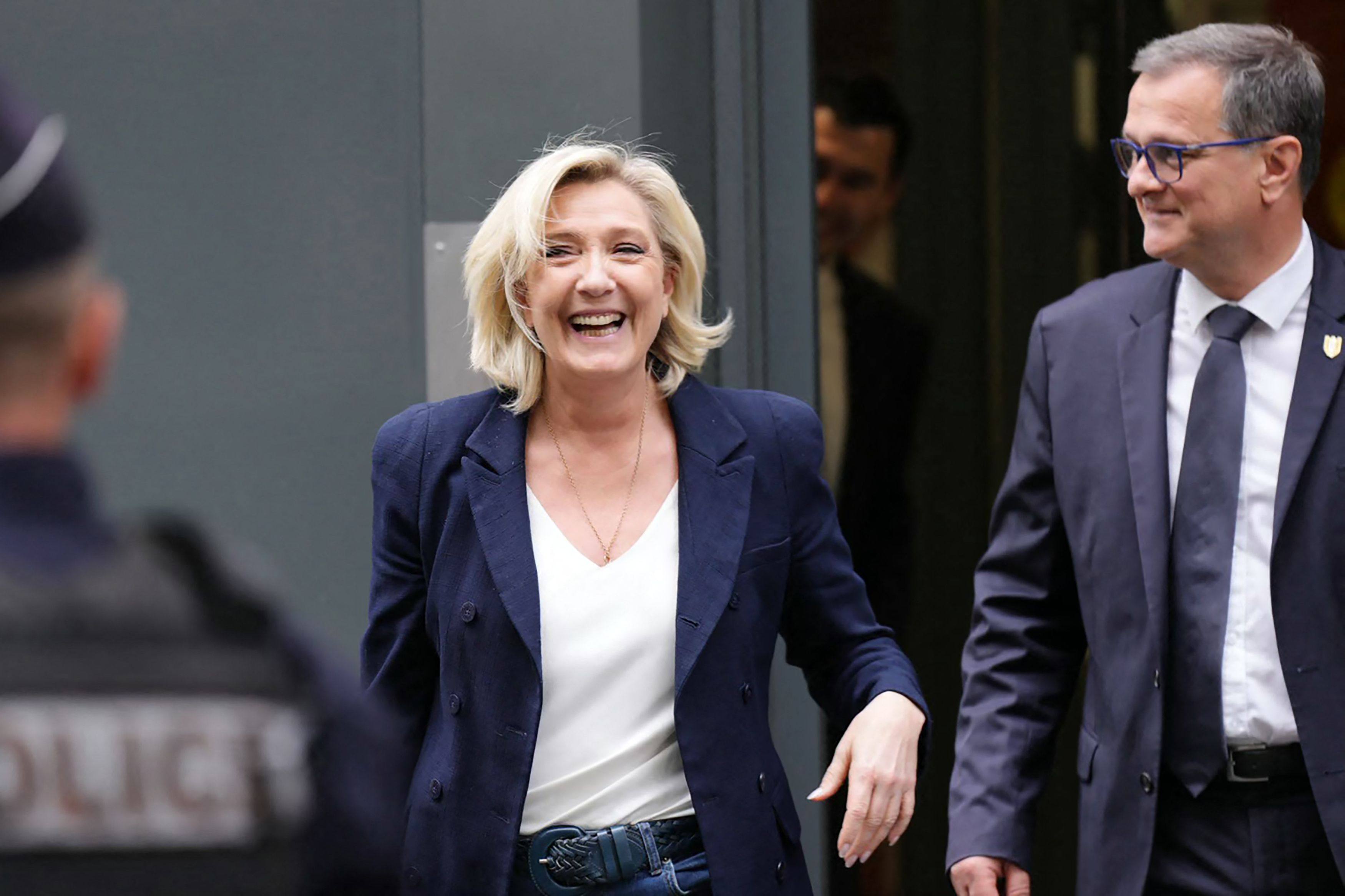 Marine Le Pen of the French far-right National Rally (RN) party and RN Mayor of Perpignan Louis Aliot leave the party’s headquarters in Paris on Tuesday. Photo: AFP