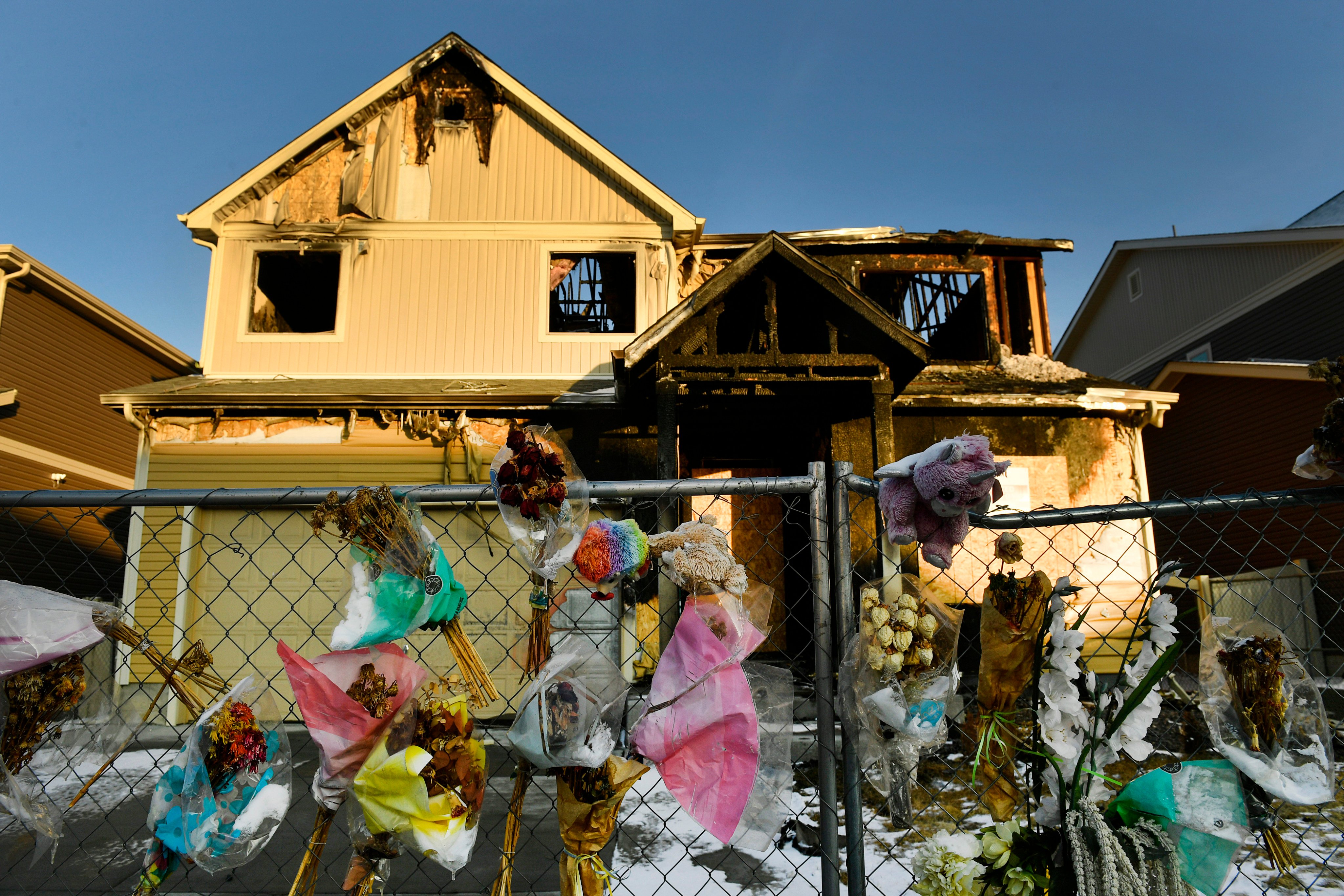 The house where five Senegalese immigrants were killed in a fire is surrounded by remembrances in Denver. Photo: The Denver Post via AP