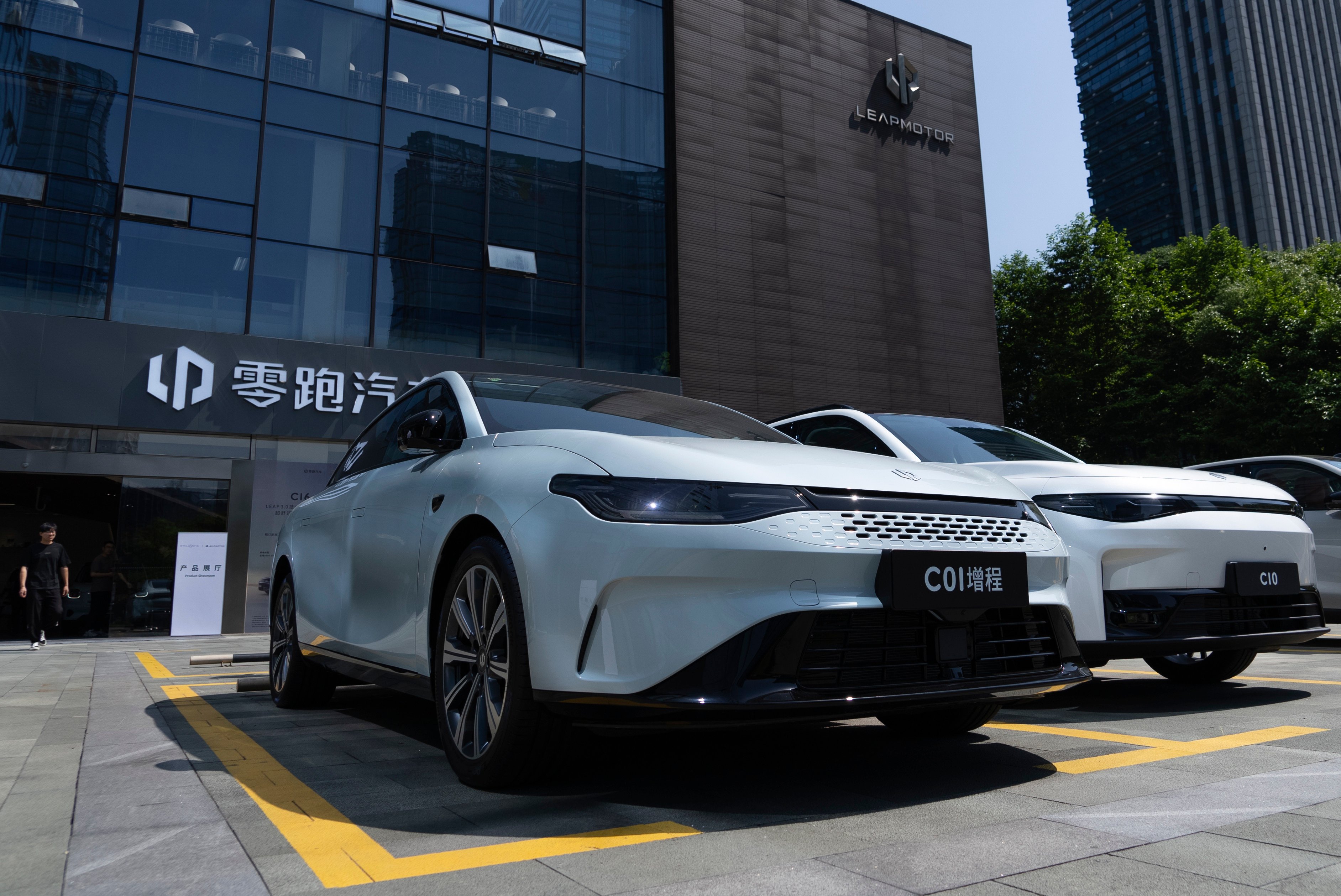 Electric vehicles are parked outside a showroom in Hangzhou, eastern China’s Zhejiang province. Photo: AP