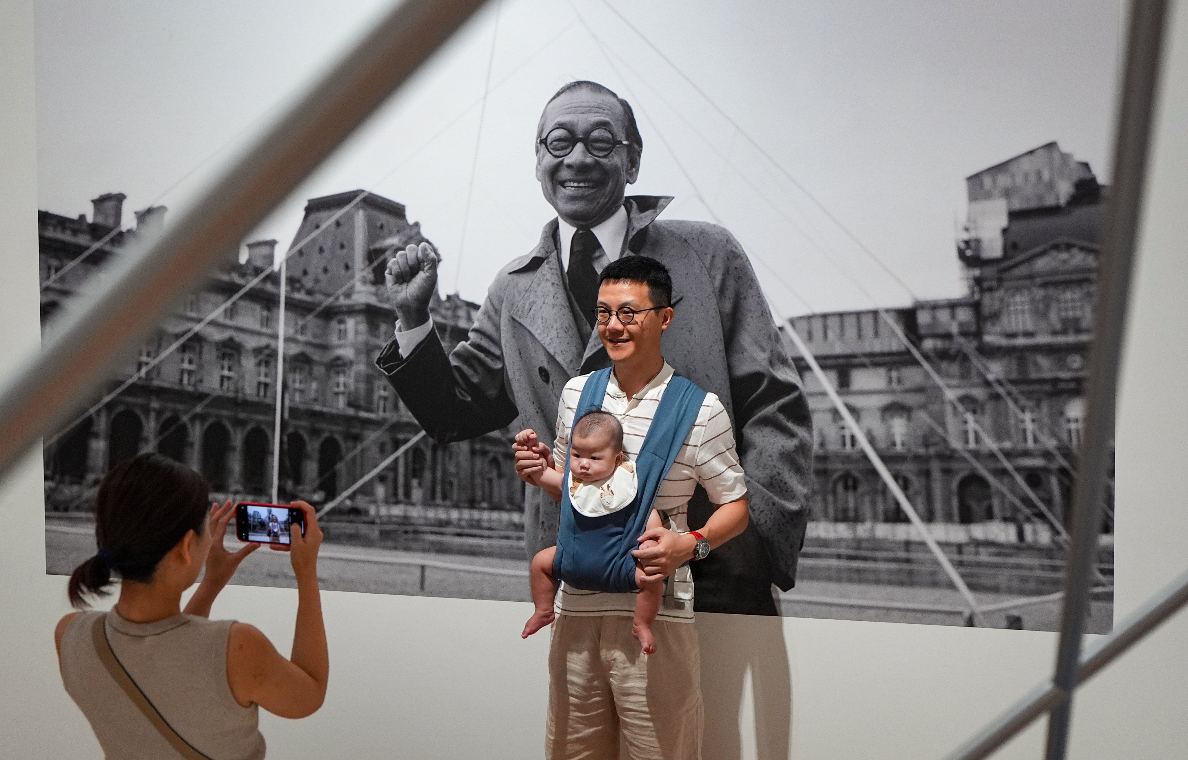 A family poses for photos at the M+ exhibition of the life and works of I. M. Pei, on June 29. The celebrated architect’s convictions are needed more than ever, if we are to find optimism in these divided times. Photo: Eugene Lee