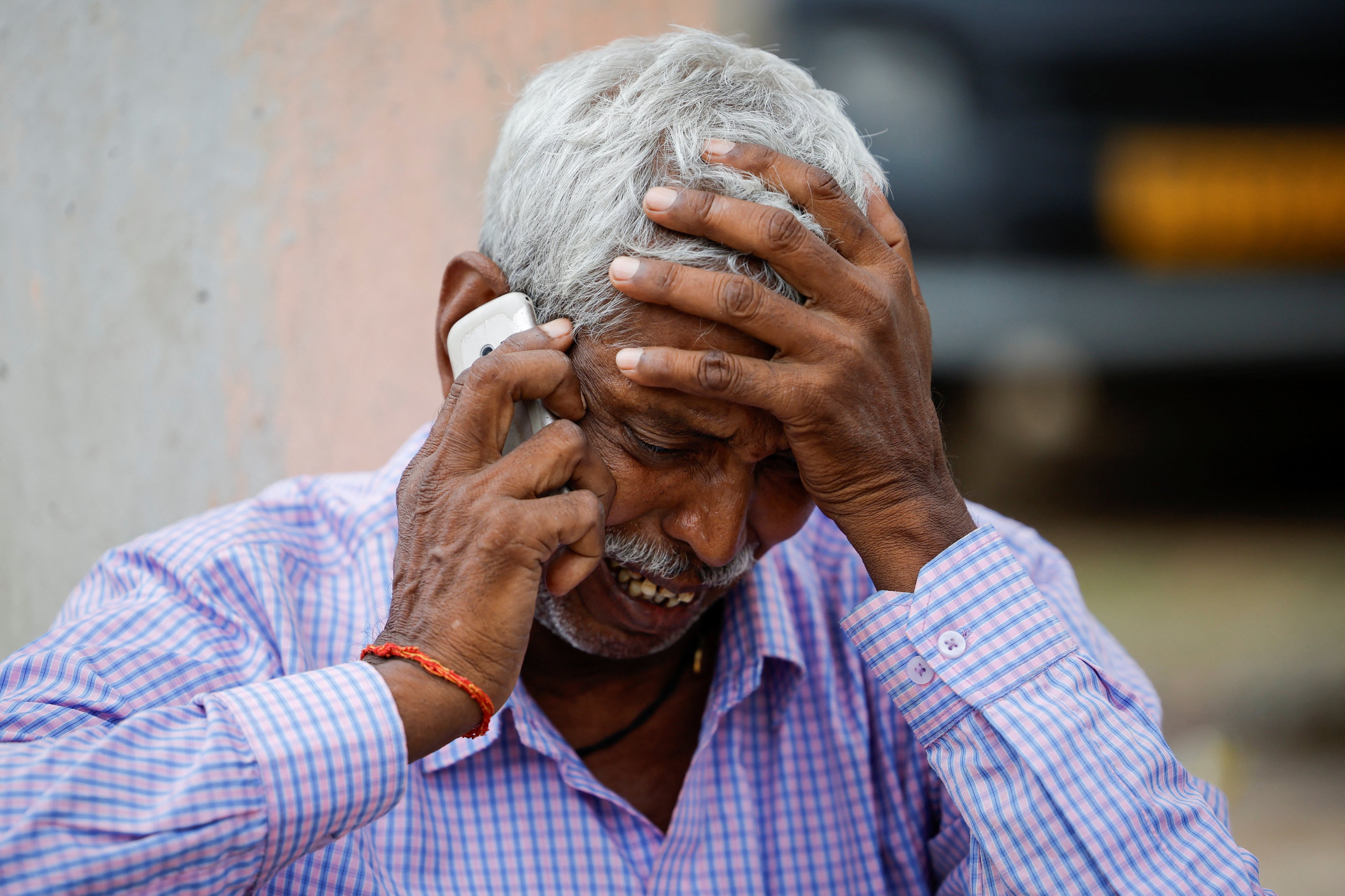 Chedilal, 65, whose daughter died in the stampede, speaks on the phone as he mourns outside a hospital in the Hathras district of Uttar Pradesh, India, on July 3. Photo: Reuters