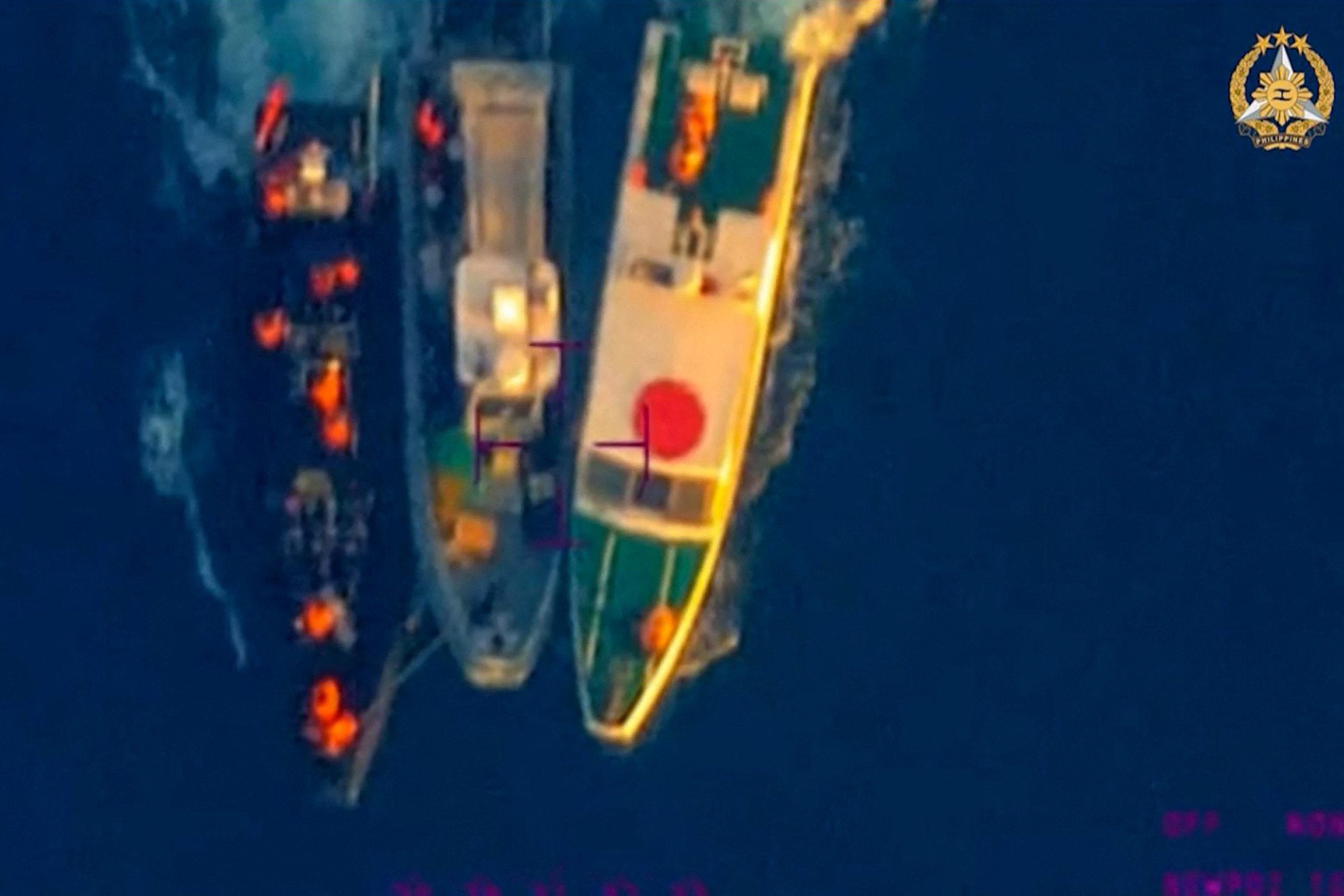 A Philippine boat between two Chinese coastguard vessels during an incident off Second Thomas Shoal in the disputed South China Sea on June 17. Photo: AFP