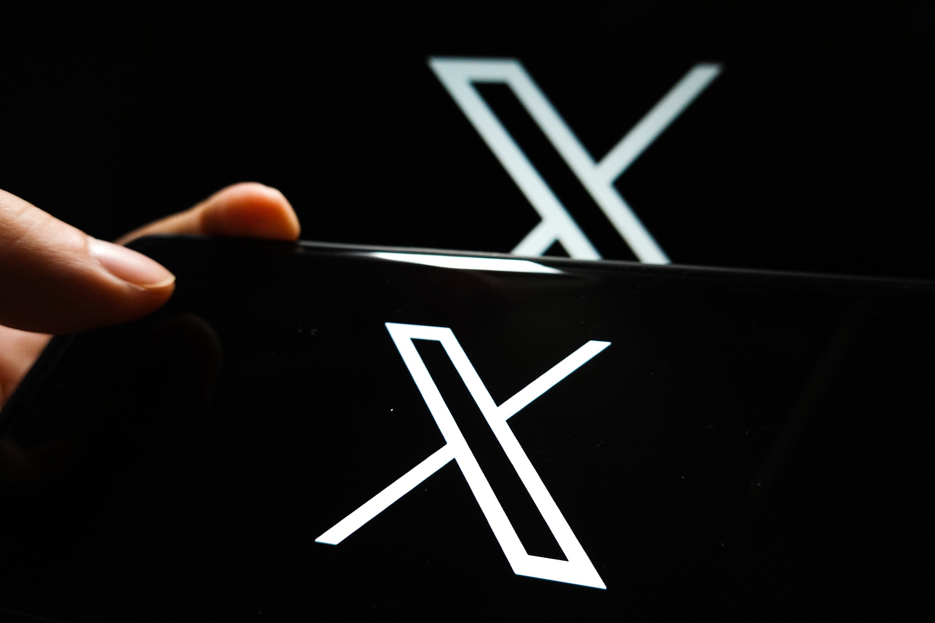 In a photo illustration, the Twitter X logo is displayed on the screen of a smartphone. Photo: SOPA Images/Zuma Press/TNS