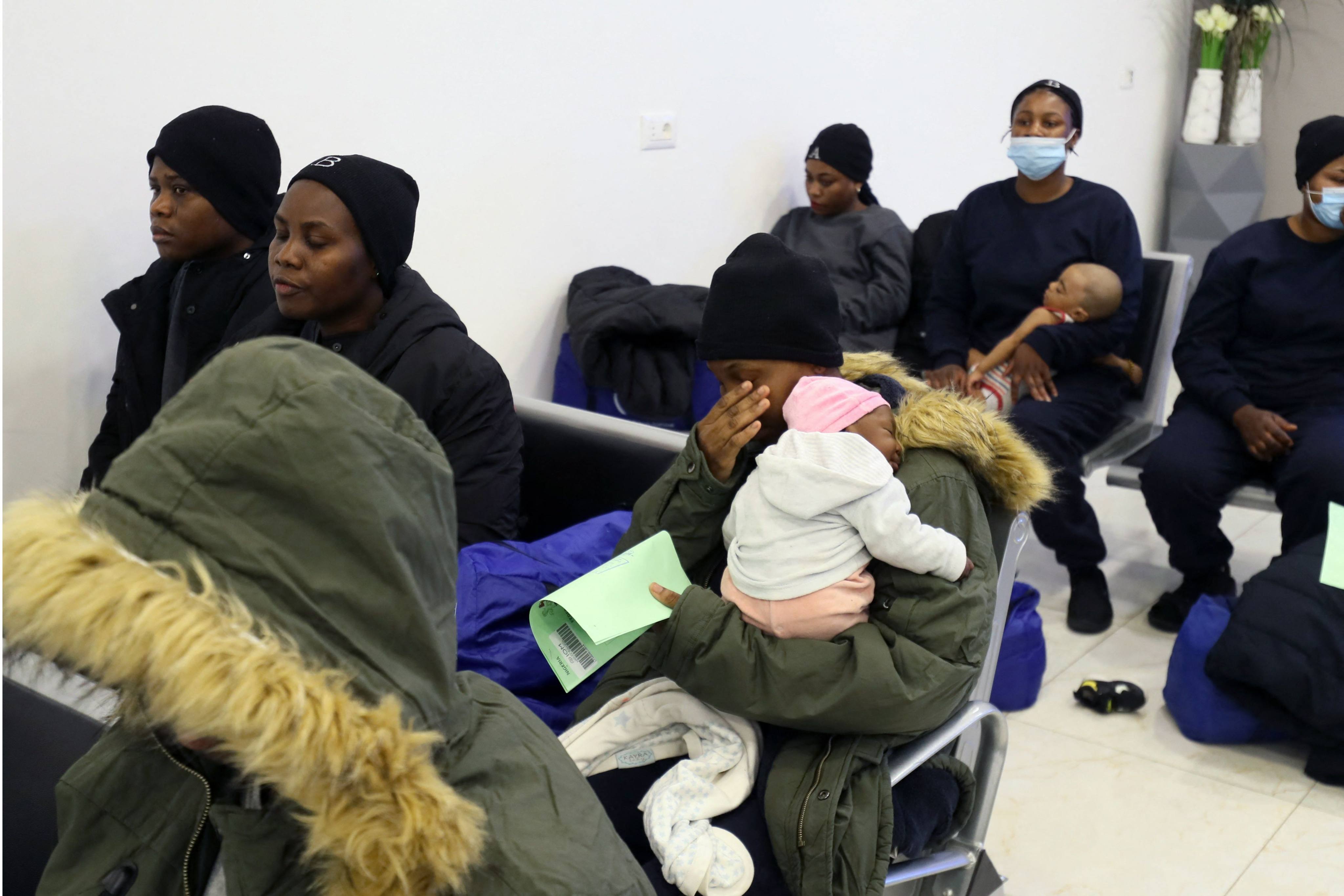 Irregular Nigerian migrants are given documents prior to their June departure from Libya’s anti-migration bureau, which is tasked with coordinating deportations of foreigners in the country illegally. Photo: AFP