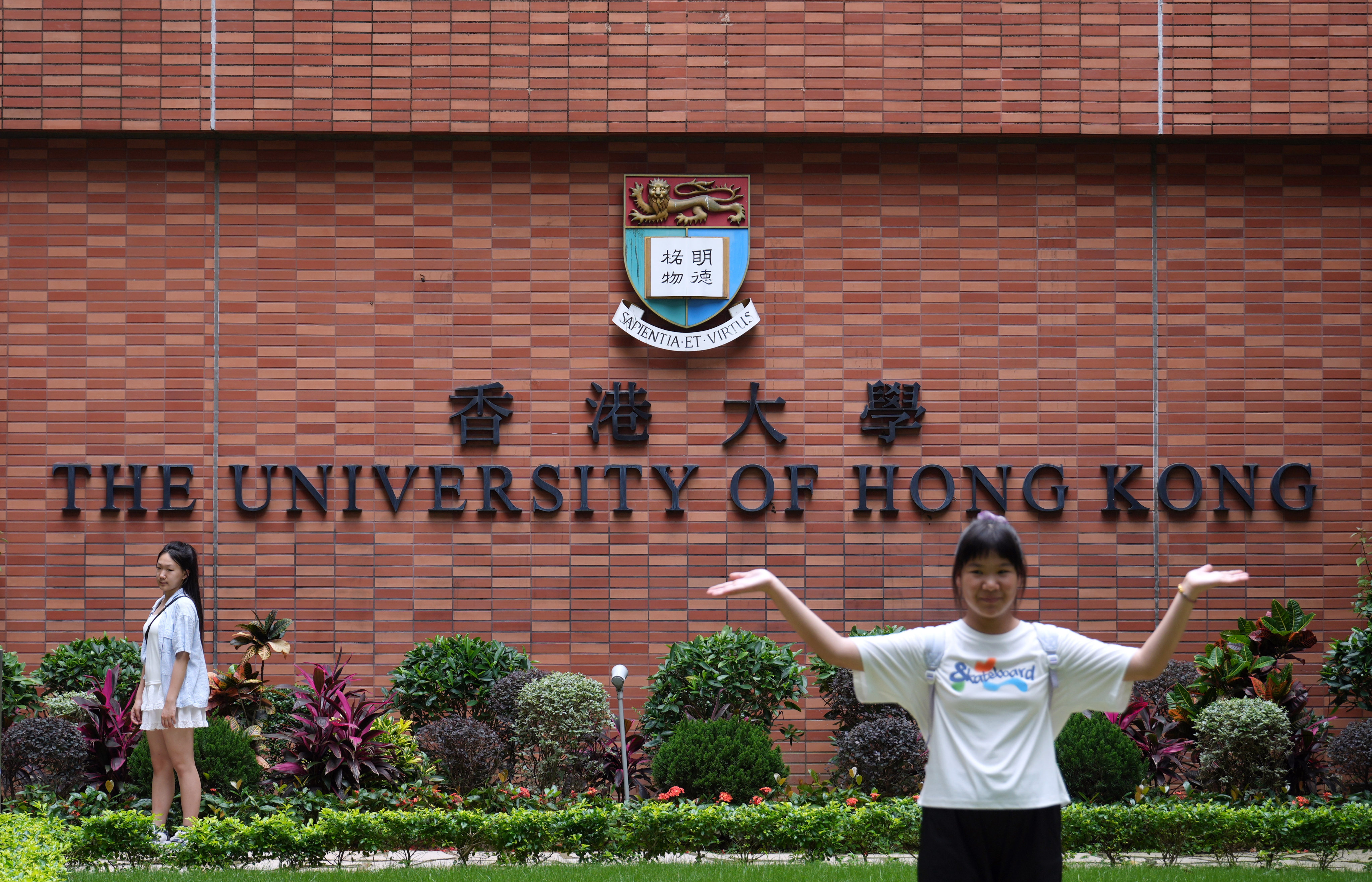 A red brick wall emblazoned with the university’s name and crest is one of the most popular spots for tourists visiting the Pok Fu Lam campus. Photo: Sam Tsang