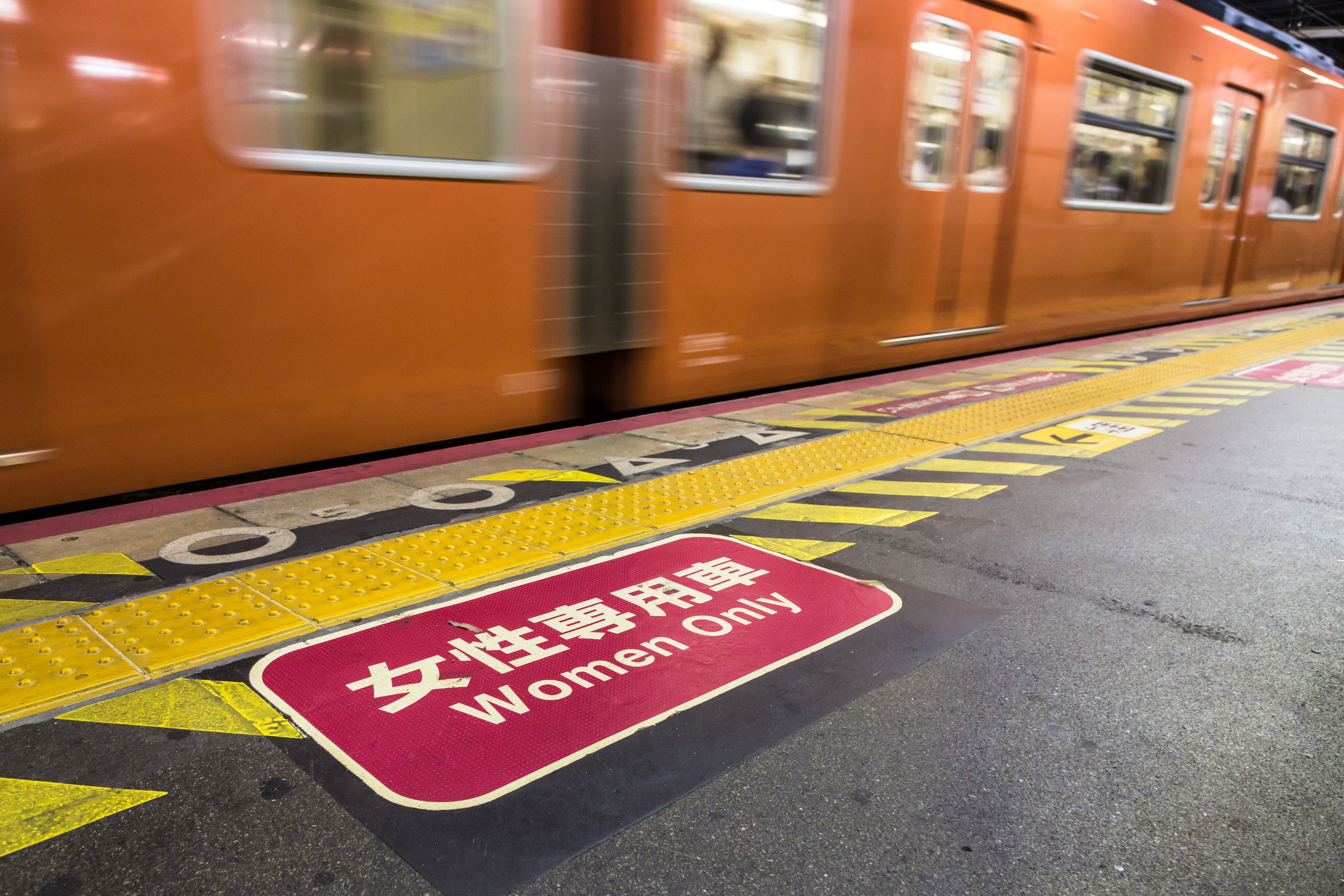 A train passes in front of a “women only” sign in the subway system in Osaka. Some cars are reserved for women to avoid harassment. Photo: Shutterstock