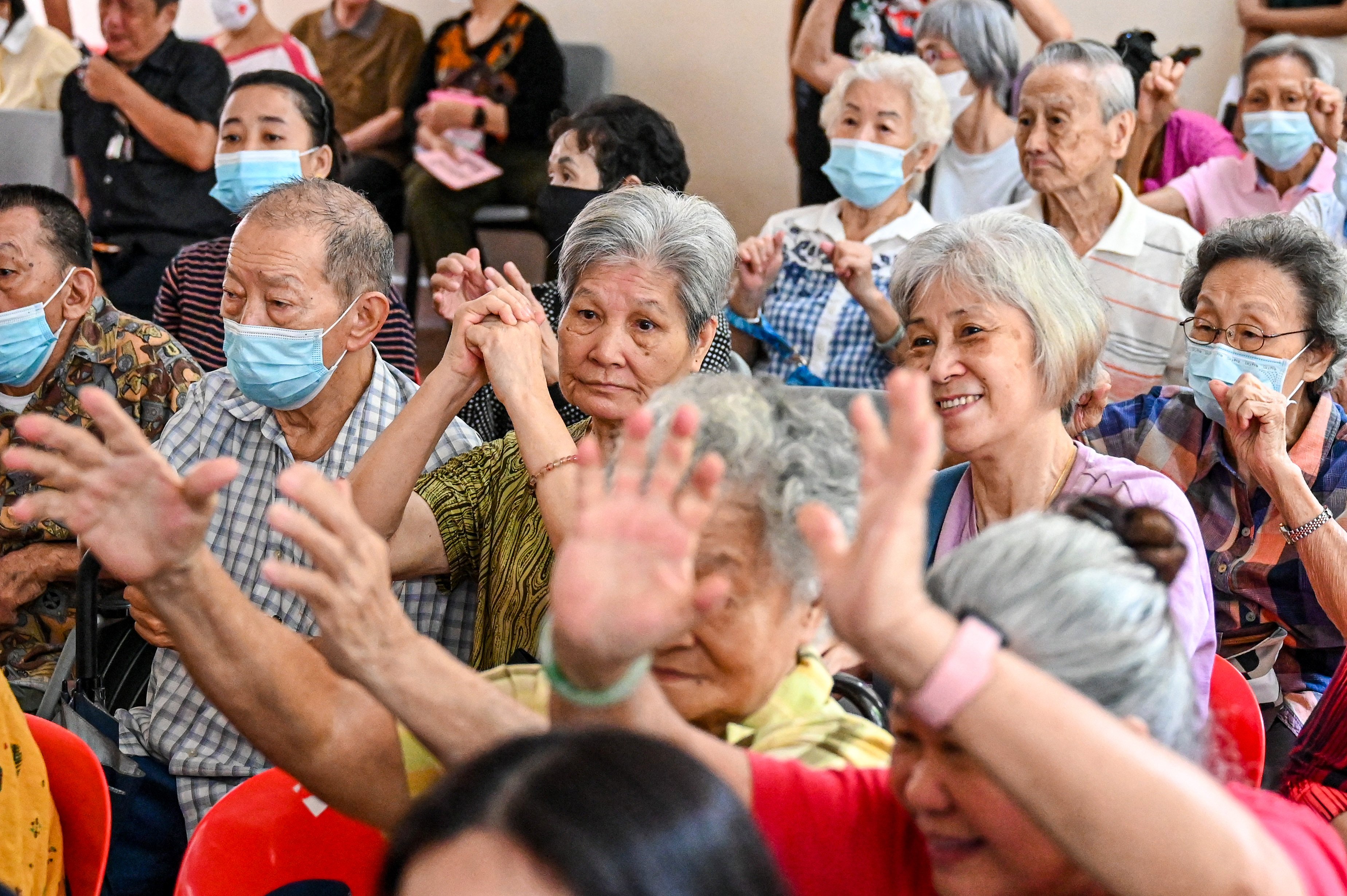 Elderly residents interact with performers at an “Active Ageing Centre” in Singapore. Around one in four of the city state’s citizens are expected to be 65 or older by 2030. Photo: AFP