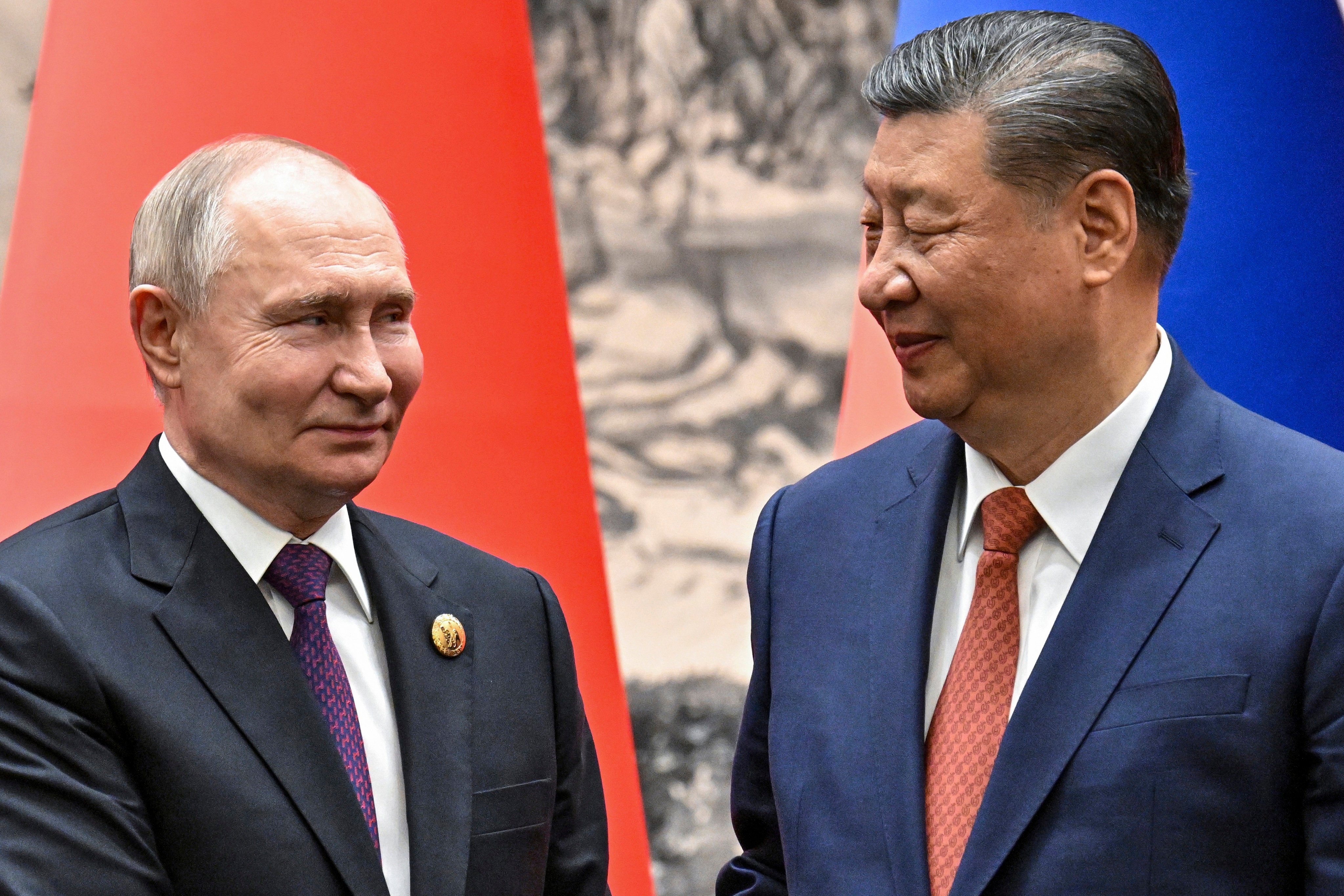 Russian President Vladimir Putin and Chinese President Xi Jinping shake hands prior to their talks in Beijing in May. Photo: Sputnik, Kremlin Pool Photo via AP