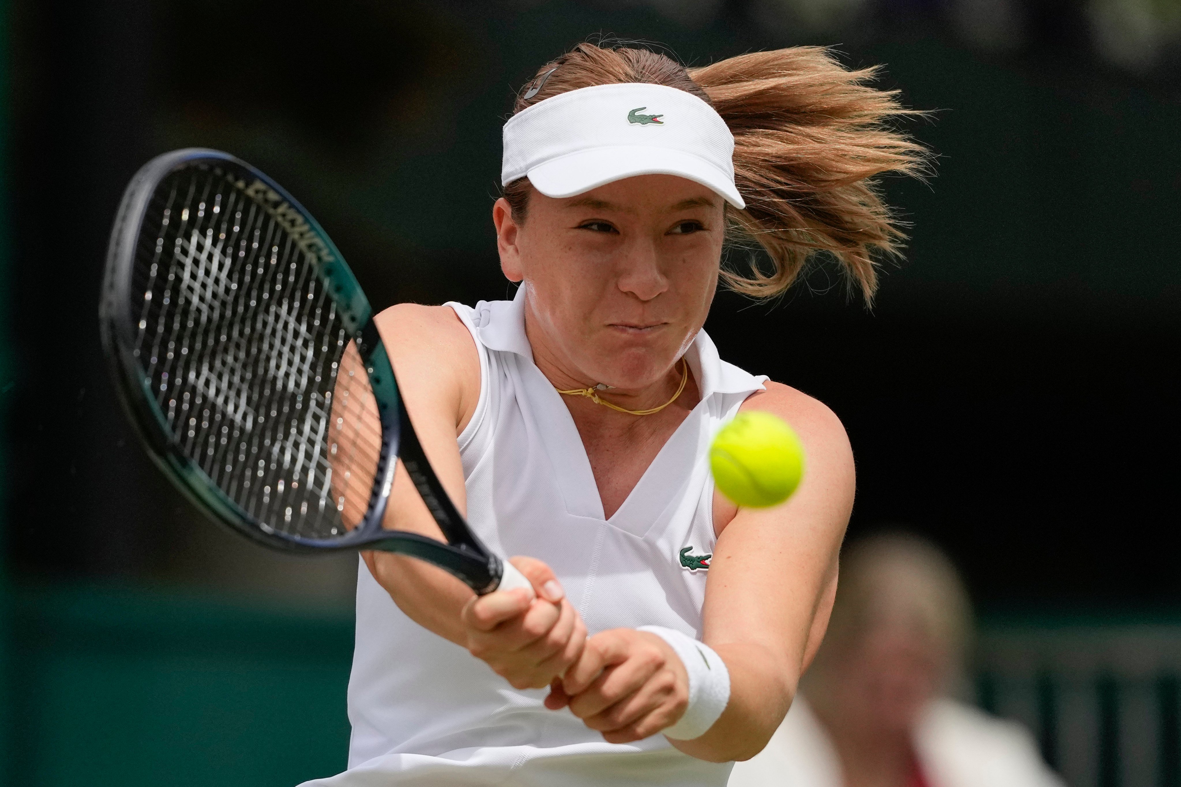 Lulu Sun plays a backhand return to Lin Zhu during their third round women’s singles match at Wimbledon. Photo: AP