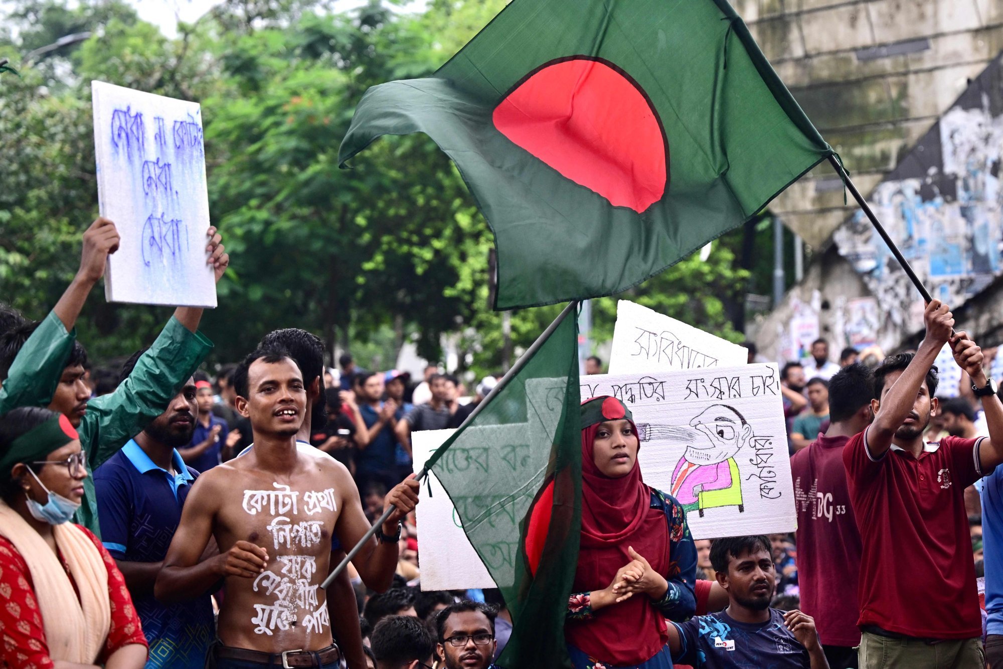 Students and job aspirants hold placards during a protest in Dhaka on July 4 against “discriminatory” quotas for government jobs. Photo: AFP